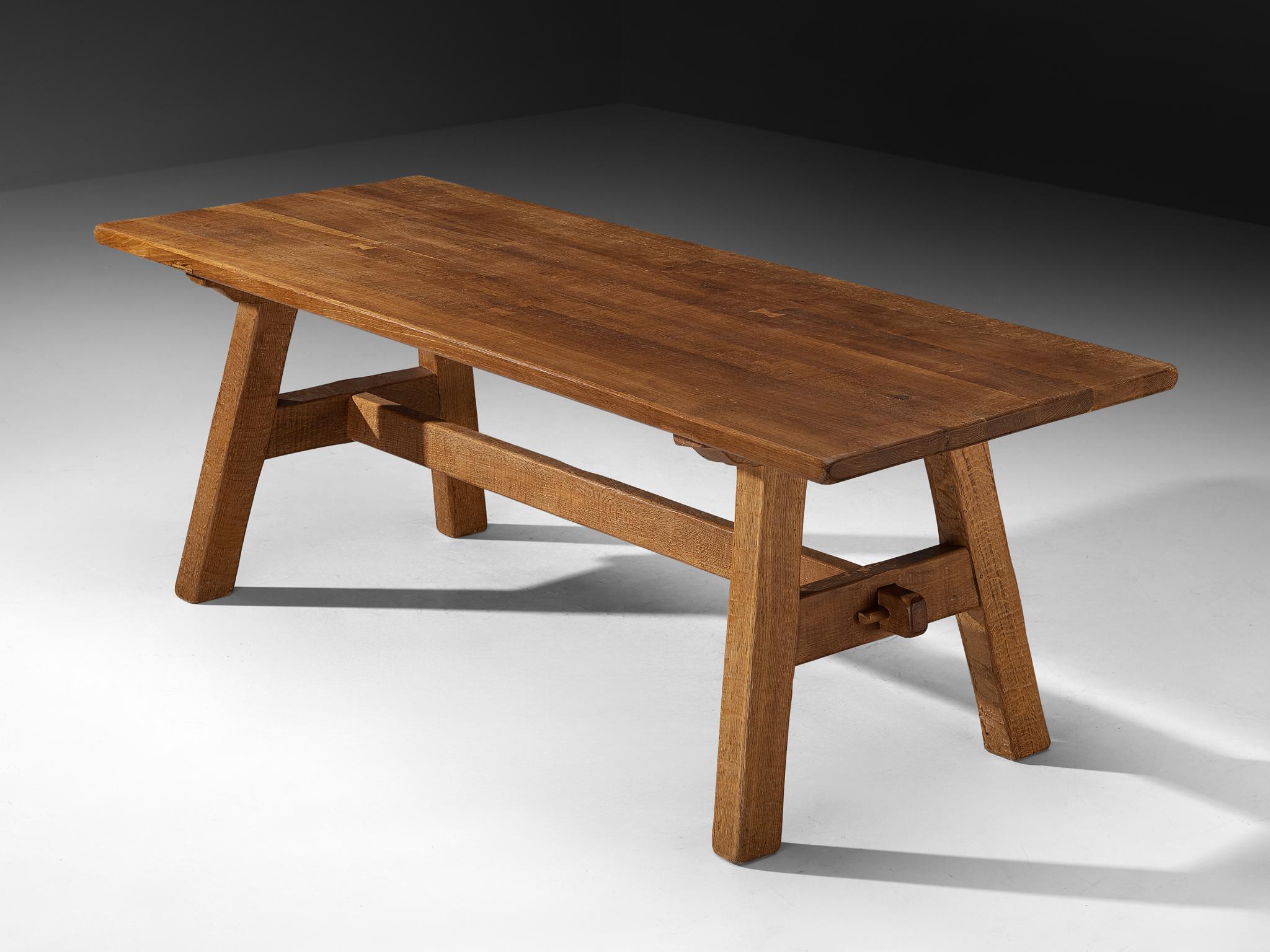 Oak Table, Europe, 1950s

This solid oak table reflects a refined balance between rustic simplicity and modern restraint. The natural grain and warm tone of the wood are accentuated by its straightforward construction, while the angled legs and