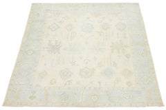Artisanal Oushak Style Wool Area Rug: Neutral Ivory with Muted Floral Motifs