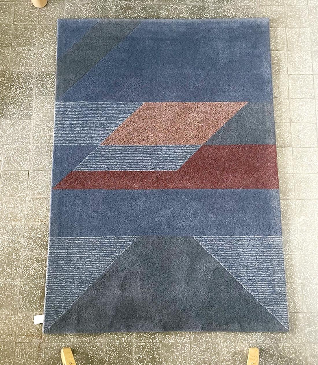Bring a touch of sophisticated artistry to your home with this artistic, hand-tufted rug from Tisca France. Made in the 1990s from 100% premium New Zealand wool, this large piece (170x240 cm) seamlessly blends retro charm with modern geometric
