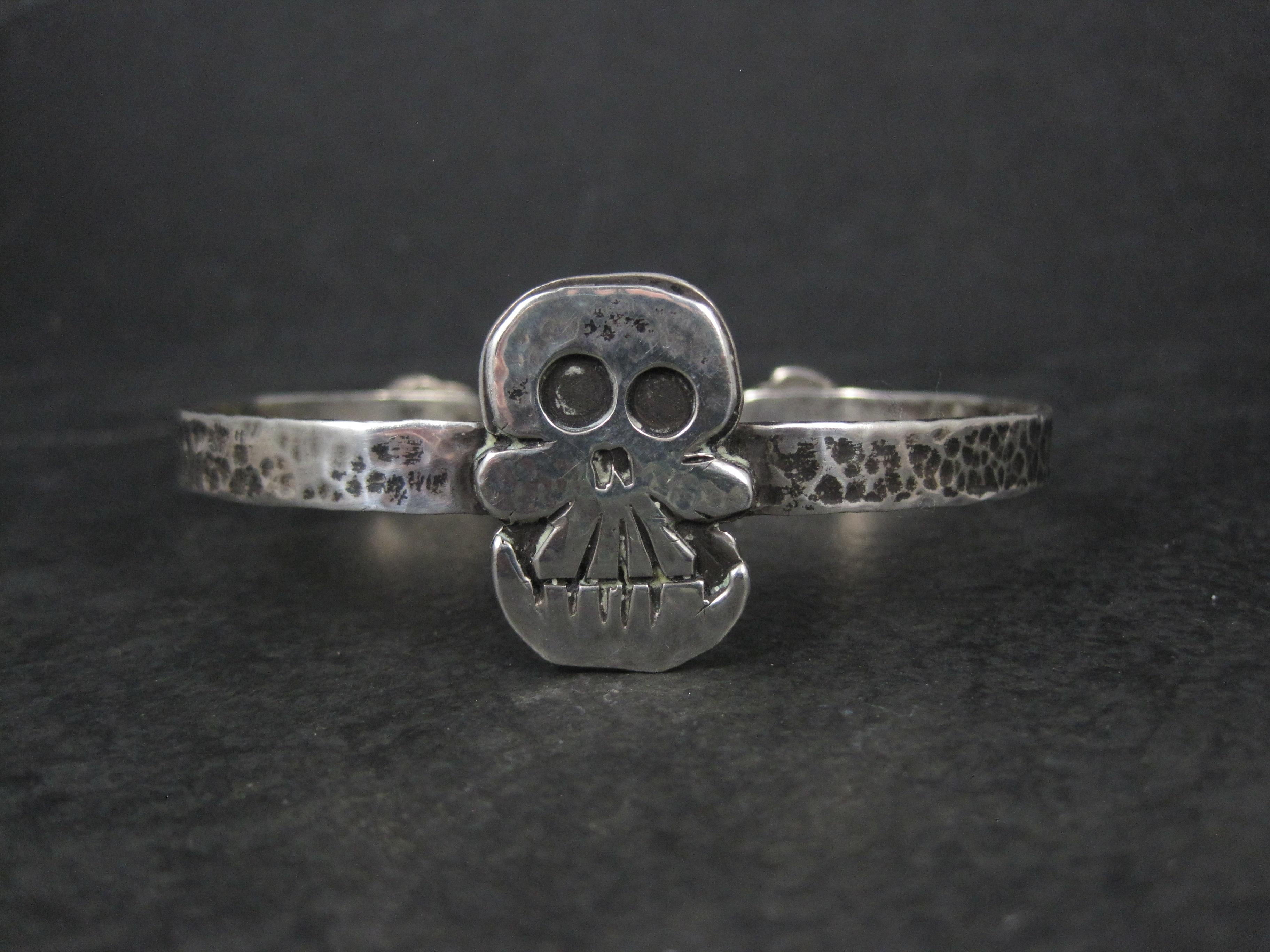 This gorgeous and unusual sterling silver skull cuff bracelet is artisian made.

The face of this bracelet measures 1 inch north to south with a 7mm band.
It has an inner circumference of 7 inches including the 1 inch gap.
Weight: 26.4 grams

Marks: