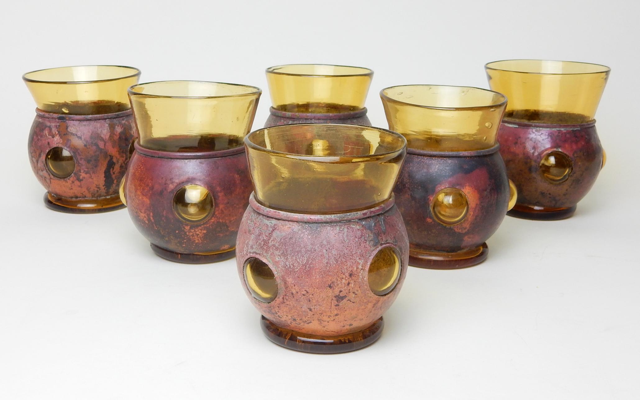 Amazing set of 6 imprisoned blown glass tumblers by artist Felipe Derflingher.
These are sculpted of hand blown amber glass into a rare flamed copper shell.
The color, age and patina in gorgeous. All are in excellent condition.
Their hand and