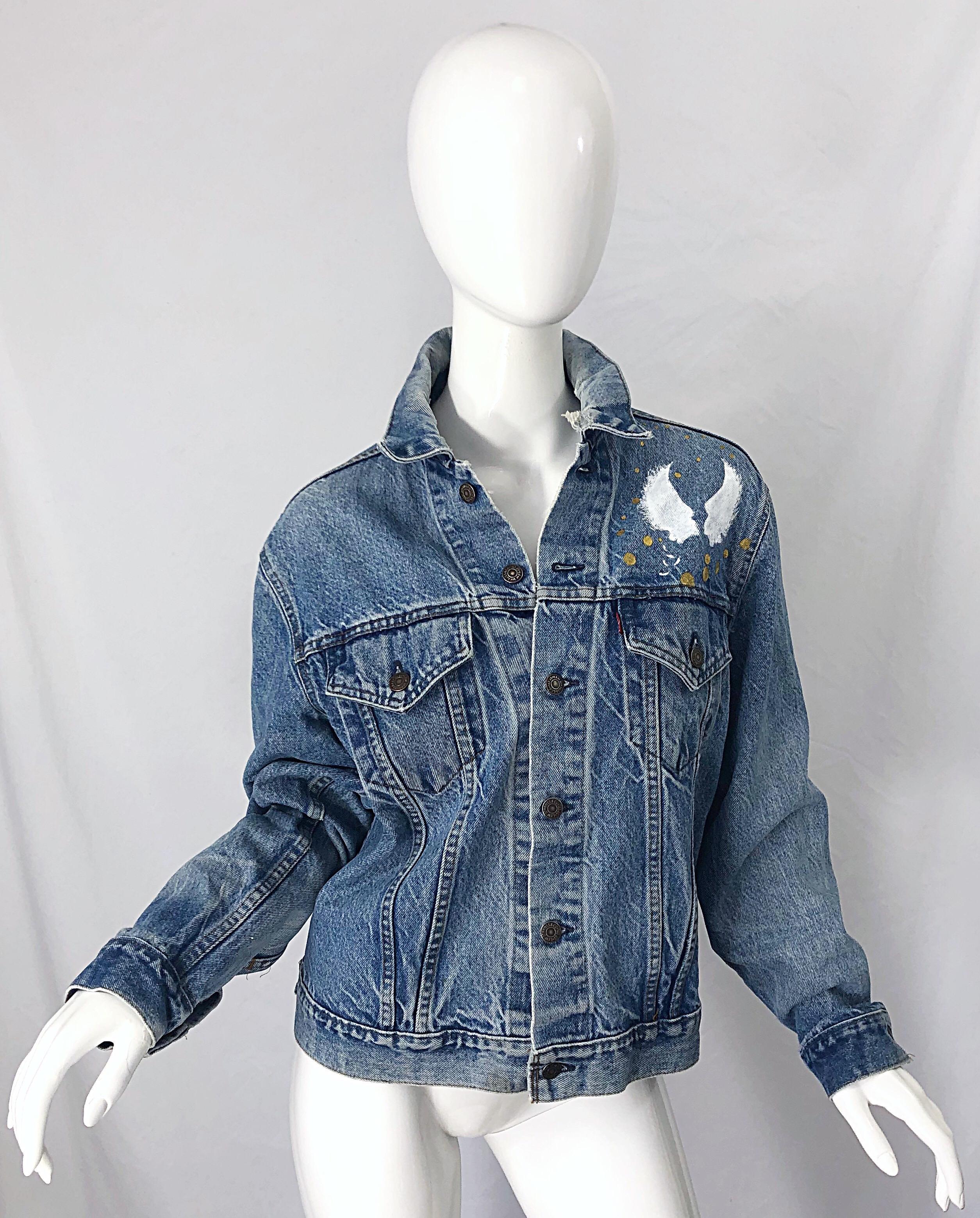 Amazing one of a kind artist hand painted 'City of Angels' unisex vintage blue jean jacket ! Angel wings in white on the top left corner of the front. Large angel hand painted on the back with the sun and moon. Crosses and polka dots in metallic