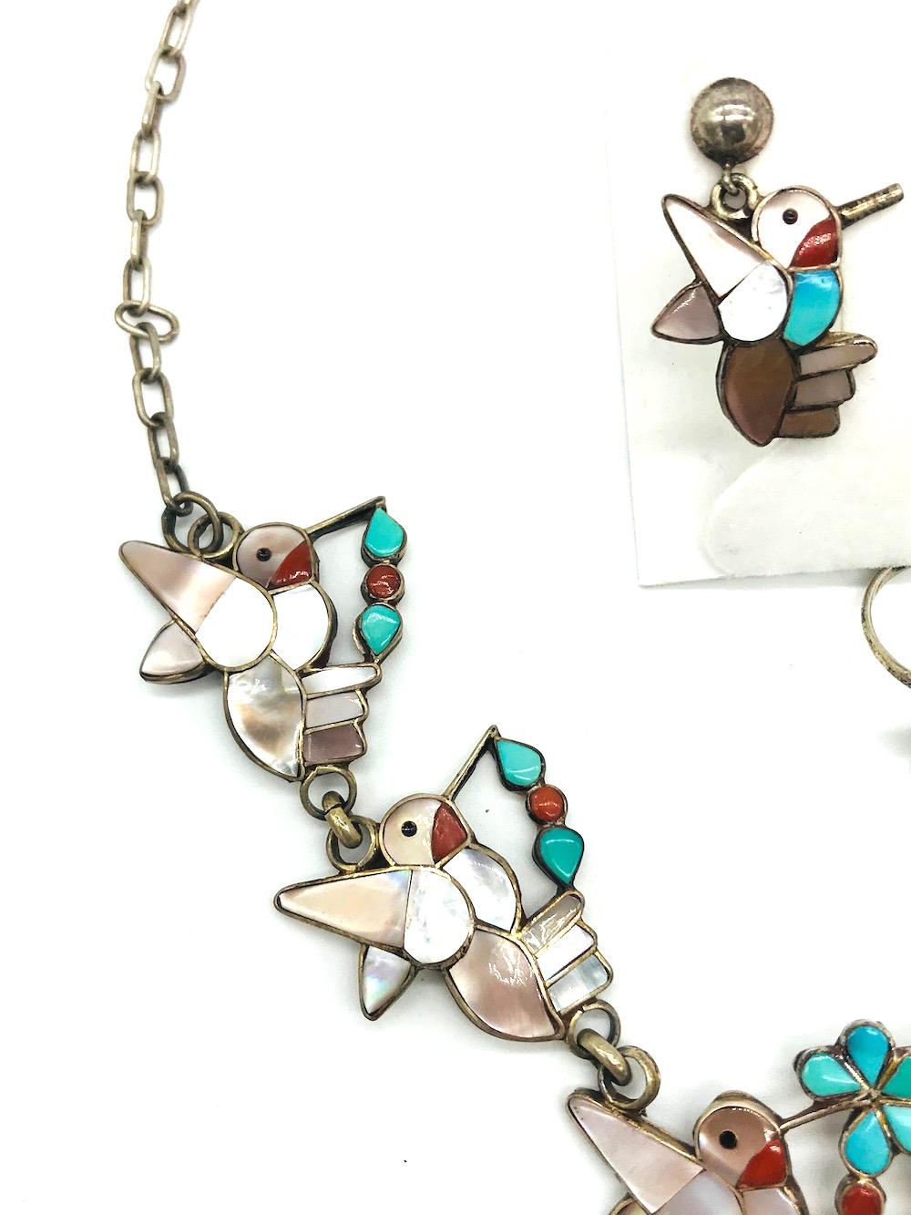 Artist Hummingbird, Earring Necklace Ring, Turquoise and Mother of Pearl Set
Intrigue detailed birds set in carved turquoise and mother of pearl. The base is sterling silver, 925. The necklace is 18 inches in length.
Earrings are 1 inch in length