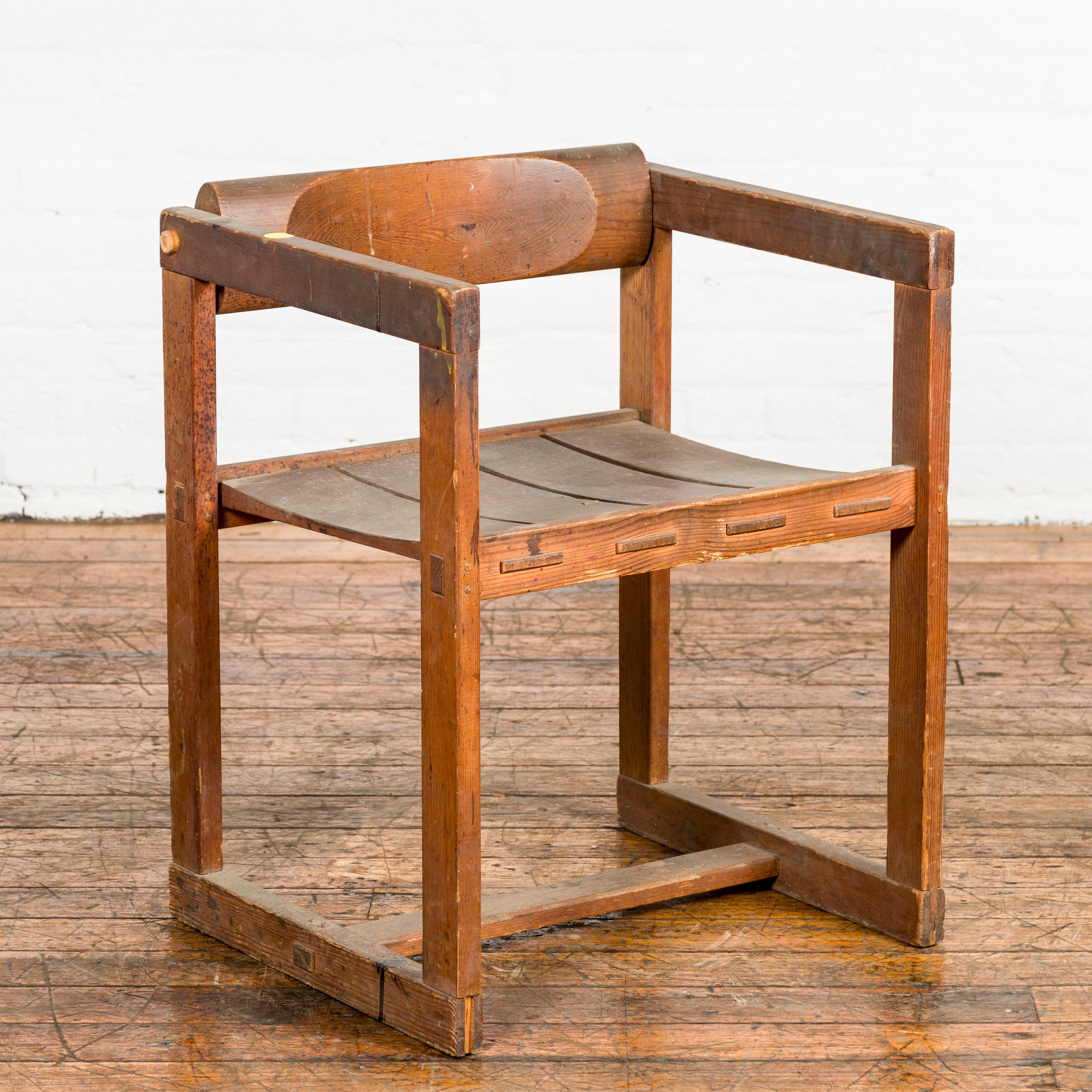 An Industrial style vintage artist desk chair with rustic character. Meet the epitome of rugged functionality: this Industrial-style vintage artist desk chair. Featuring a slatted seat that subtly curves inward, the chair beckons you to take a seat.
