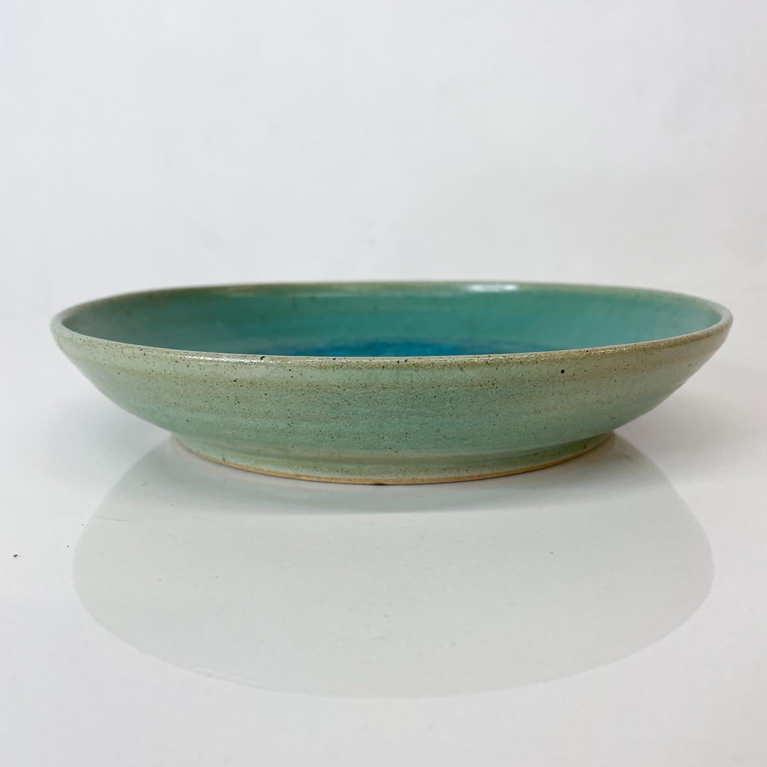 Presenting:
By renowned author and ceramicist, Jade Snow Wong, decorative dish ceramic pottery art in Turquoise San Francisco, CA
circa 1955
Ceramic pottery with enamel glass inserts. Hand signed and numbered on reverse.
Dimensions: 8 Diameter x