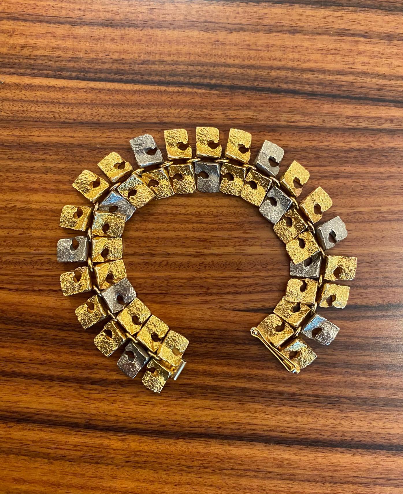 A 14 karat highly unusual bracelet, in that Bjorn Weckstrom uses two colors of gold - white and yellow - in this flexible link bracelet, 1965. Finland. Stamped BRW, 585. Finnish hallmark.
The length of the bracelet is 7.60