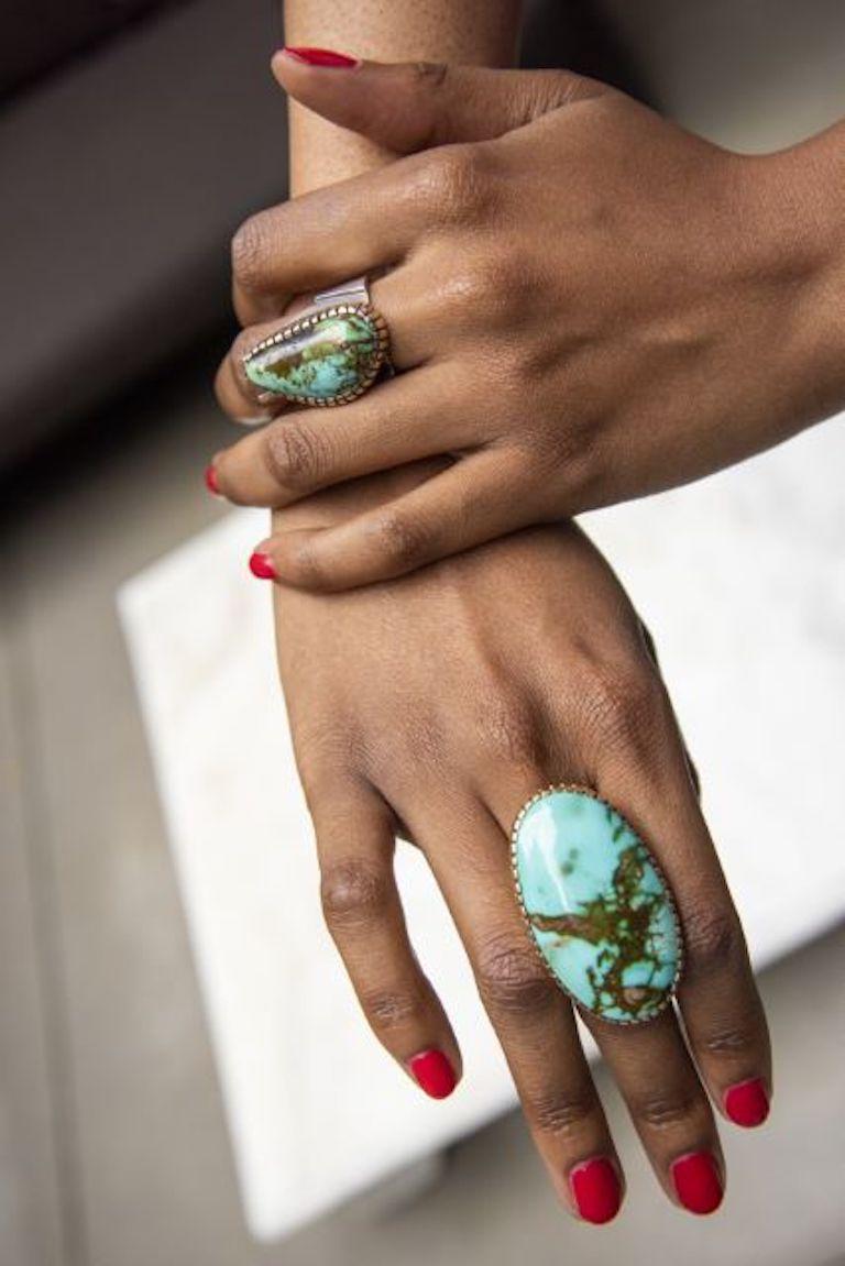 A silver ring with gold bezel encasing a large Royston turquoise by Verma Nequatewa, c. 2018. Hopi. Stamped Sonwai, and maker's mark. Artist Jewel. 
Ring size 7. This ring measures 1.75