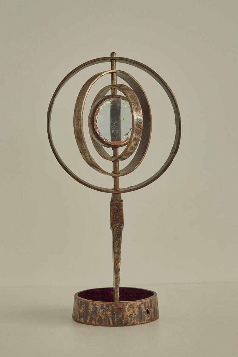 Proveniente dalla Francia, questo pezzo unico è caratterizzato da cerchi concentrici in metallo patinato che circondano uno specchio centrale invecchiato. Un sorprendente oggetto decorativo con un design di ispirazione celeste e una lavorazione