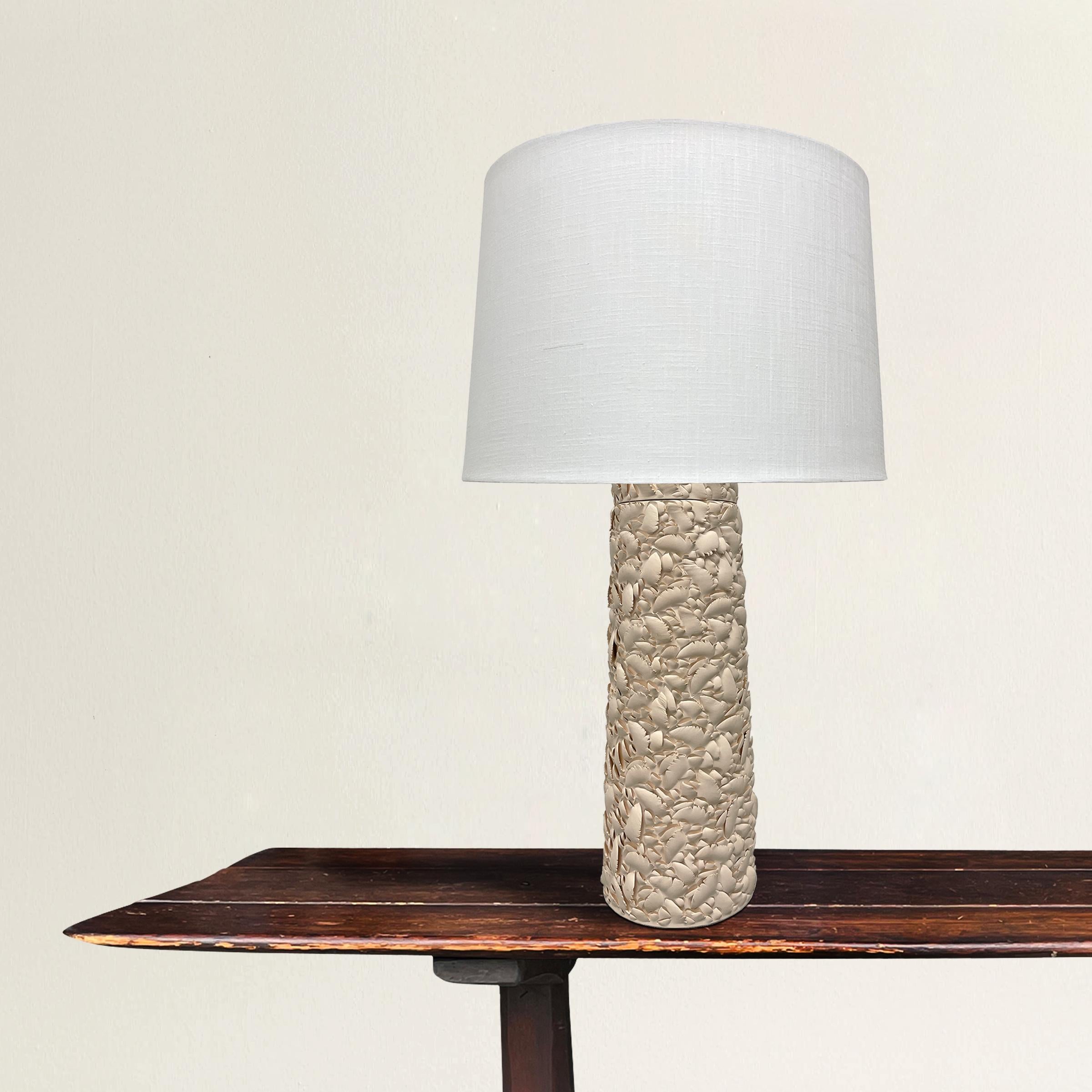 An incredible artist-made porcelain table lamp with the most amazing texture made by cutting into the surface of the smooth porcelain thousands of times. An unbelievable piece that can hold its own in any modern or traditional interior! New white