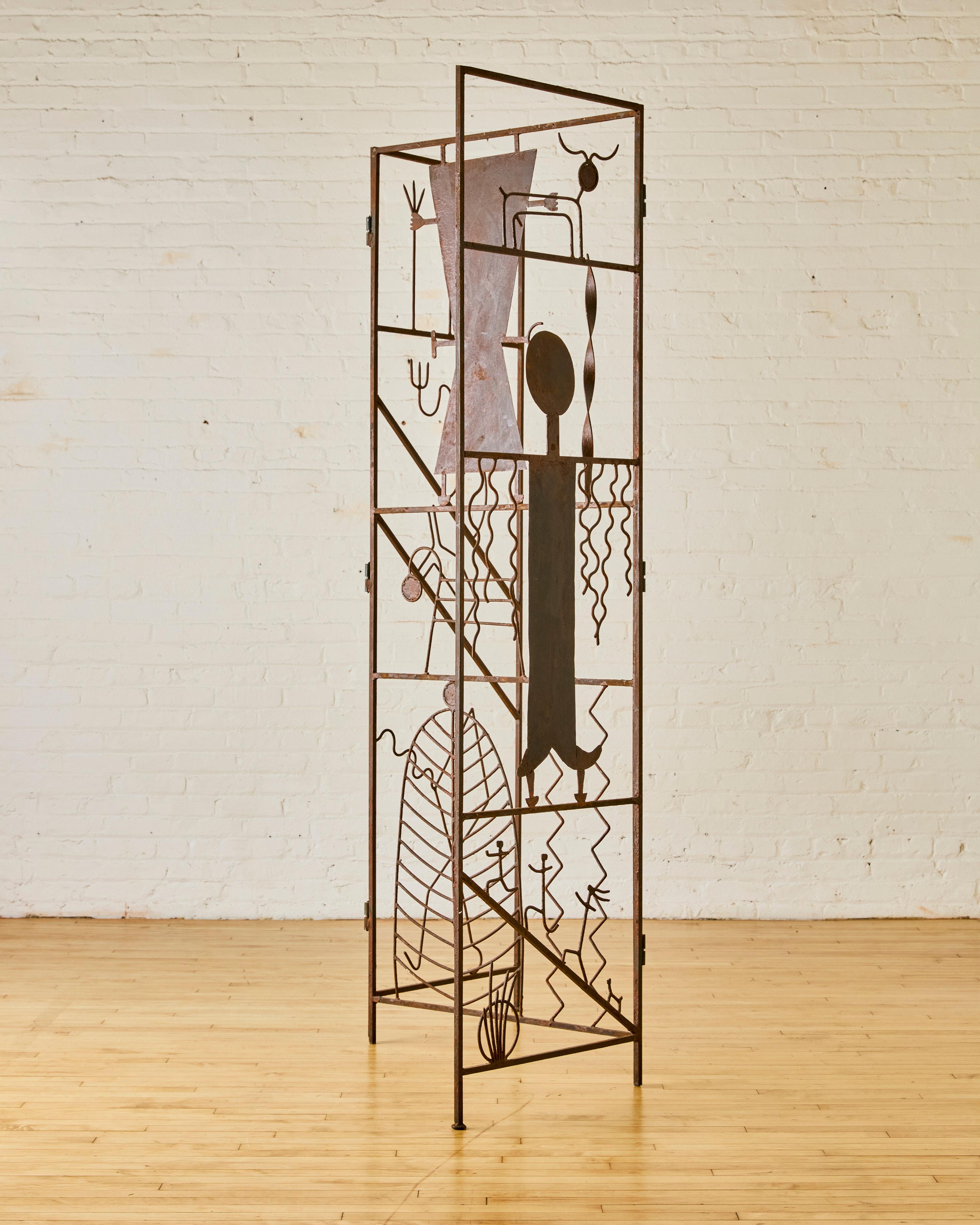 Artist made tri-folding iron screen with various figural designs.