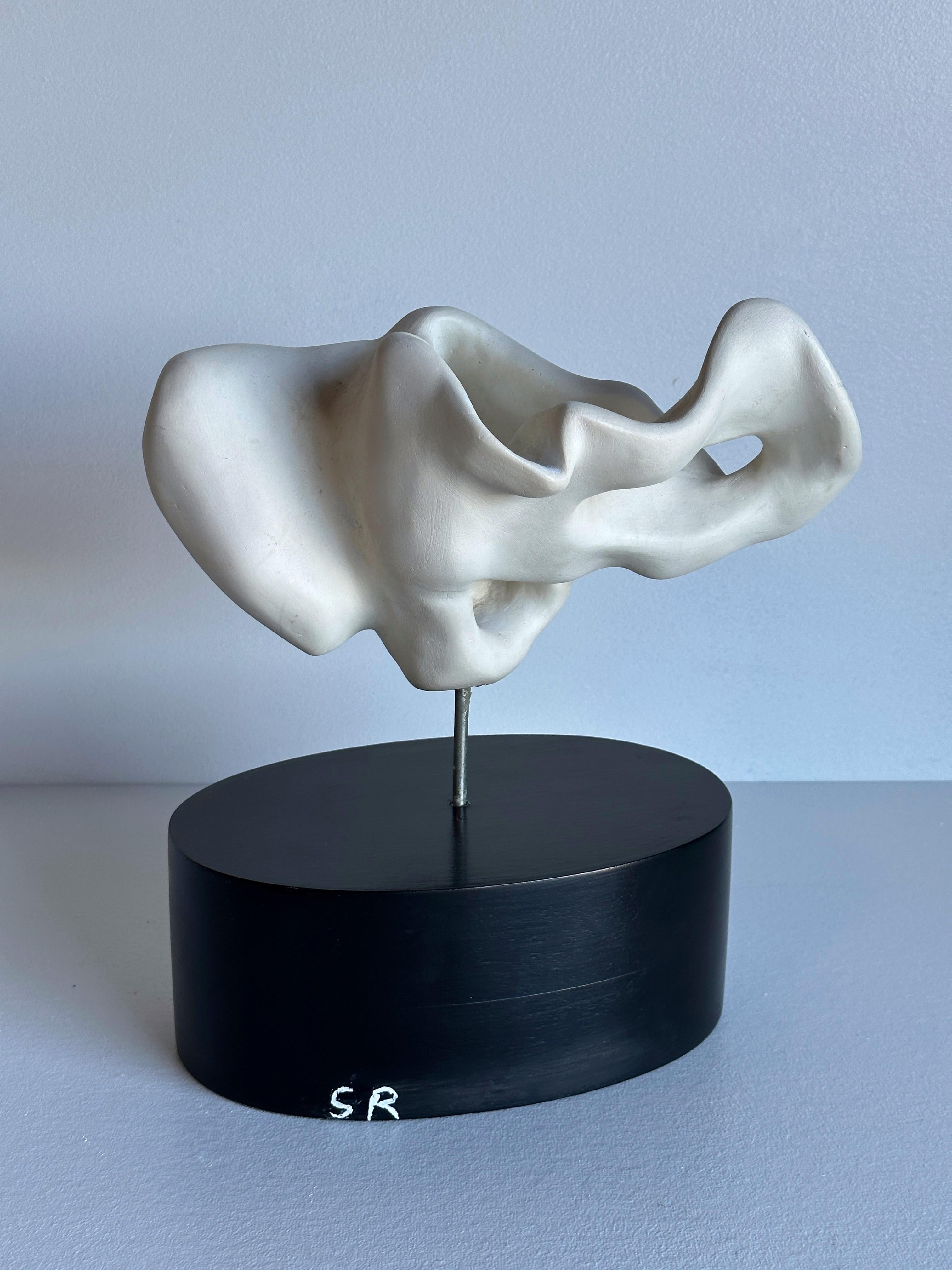White Plaster Biomorphic Tabletop Sculpture Mounted on Black Wood Stand, signed SR. Artist unknown. 
