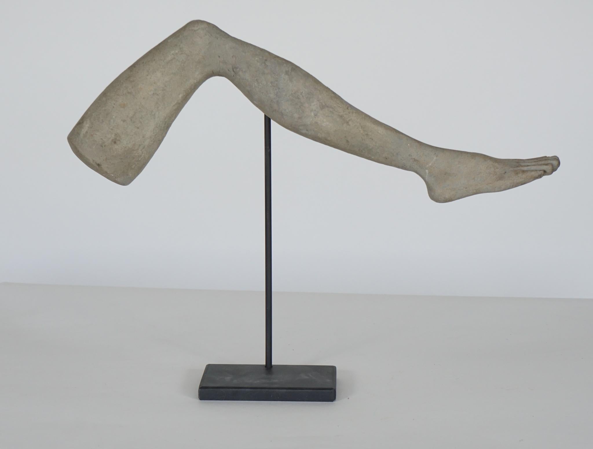 Uniquely displayed, hand carved model of an adult leg. (Leg revolves 360 degrees.) Beautifully carved with original paint.