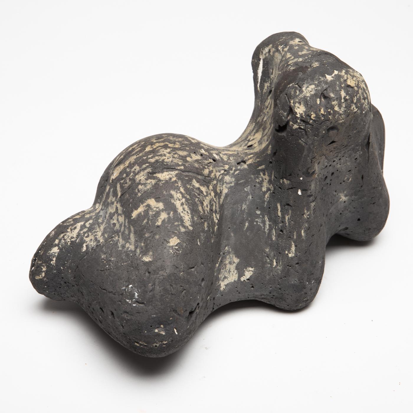 Abstracted sculpture of a reclining woman leaning on her elbows, made of coloured concrete ore pumice, unreadable signed on the underside.
 