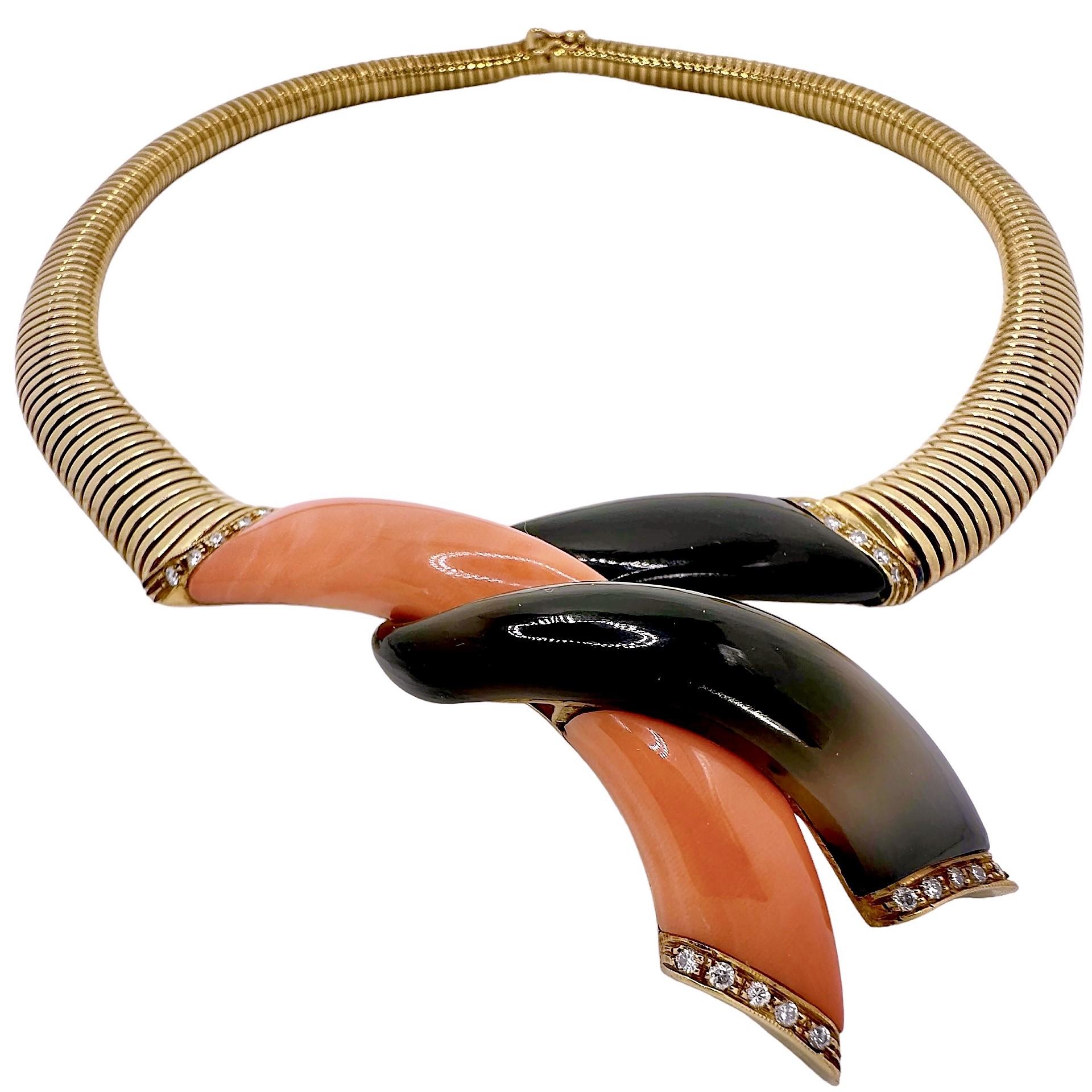This vintage Italian fashion necklace crafted in 18k yellow gold is a wonderful example of just how adept Italian workman are at creating palpable and lovely fine jewelry. This artsy piece, has at it's center, a large coral and onyx section that