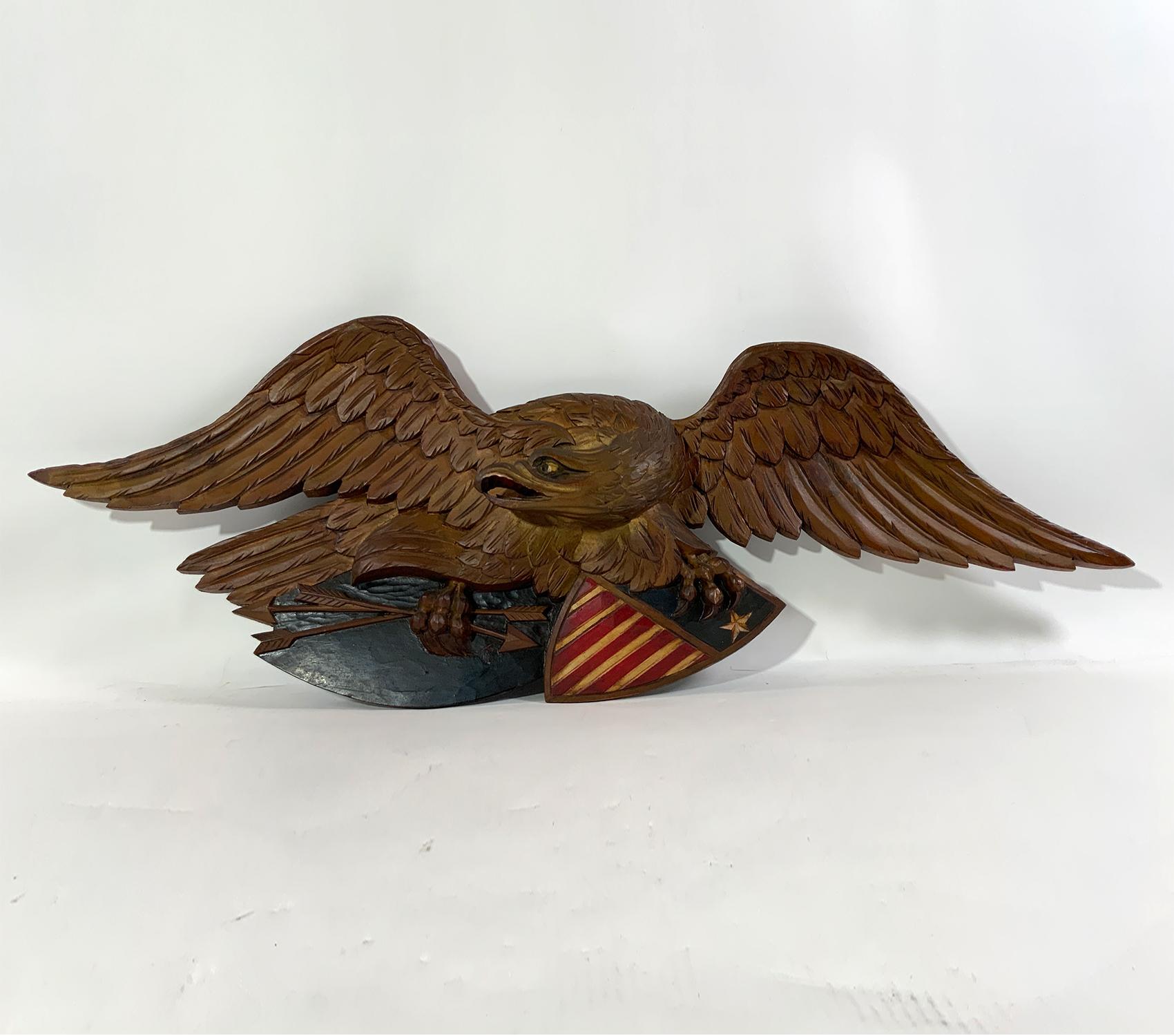 Louisburg Eagle by Artistic Carving Company of Boston. One of the larger sizes offered by this venerable Boston Carver of American Eagles. Eagle is clutching two arrows in one talon and patriotic shield on the other. With rich patina. Circa 1950.