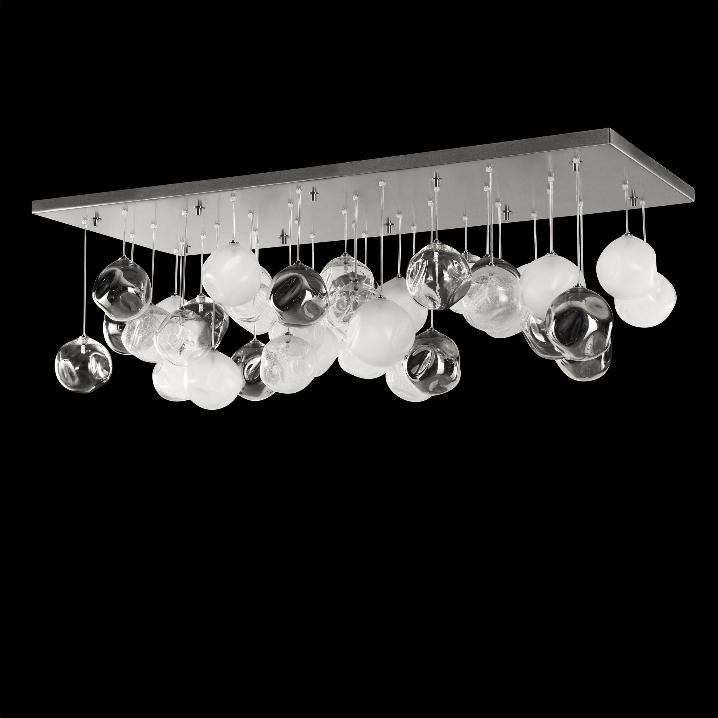 Artistic ceiling lamp, glass spheres in clear, satined, mirrored and pulegoso size 65x160cm.
Elegant and unmistakable, suggestive and poetical, soft and delicate are some of the adjectives that can be used to describe the blown glass ball