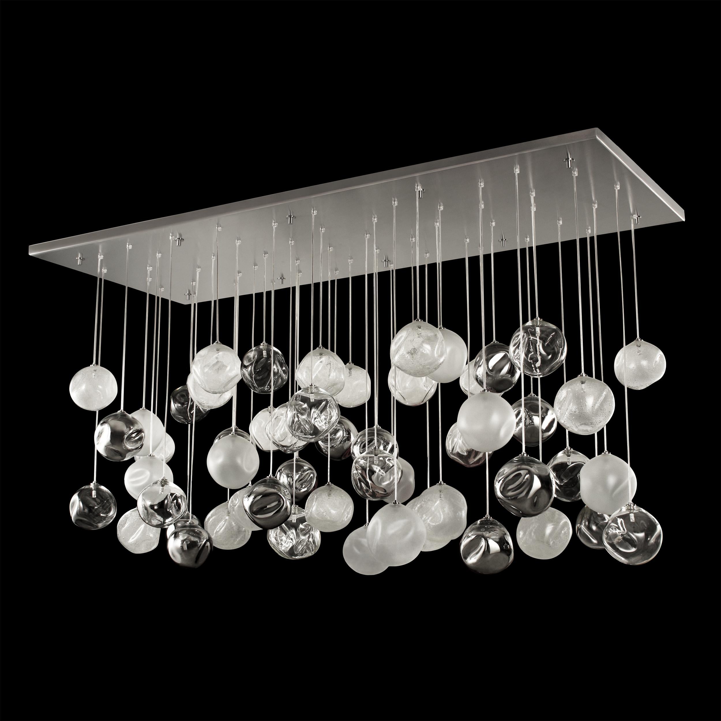 Artistic ceiling lamp, glass spheres in clear, satined, mirrored and pulegoso size 80x200cm
Elegant and unmistakable, suggestive and poetical, soft and delicate are some of the adjectives that can be used to describe the blown glass ball chandelier