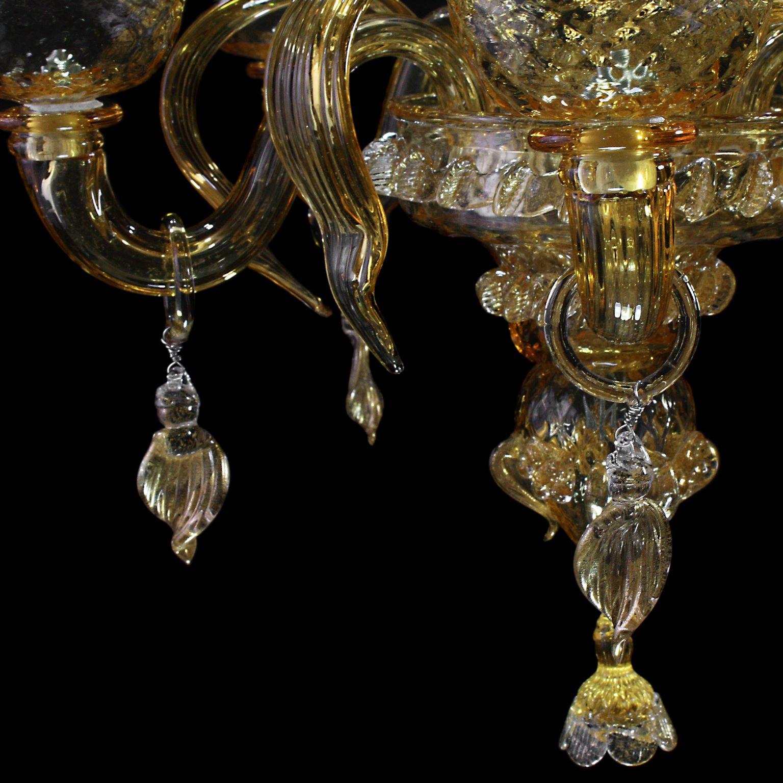 Artistic chandelier 5 arms in amber Murano glass and gold details Springtime.
The peculiar characteristic of this lighting work is the richness of its decorations. 
Springtime reflects the authentic murano glass tradition, which has become famous
