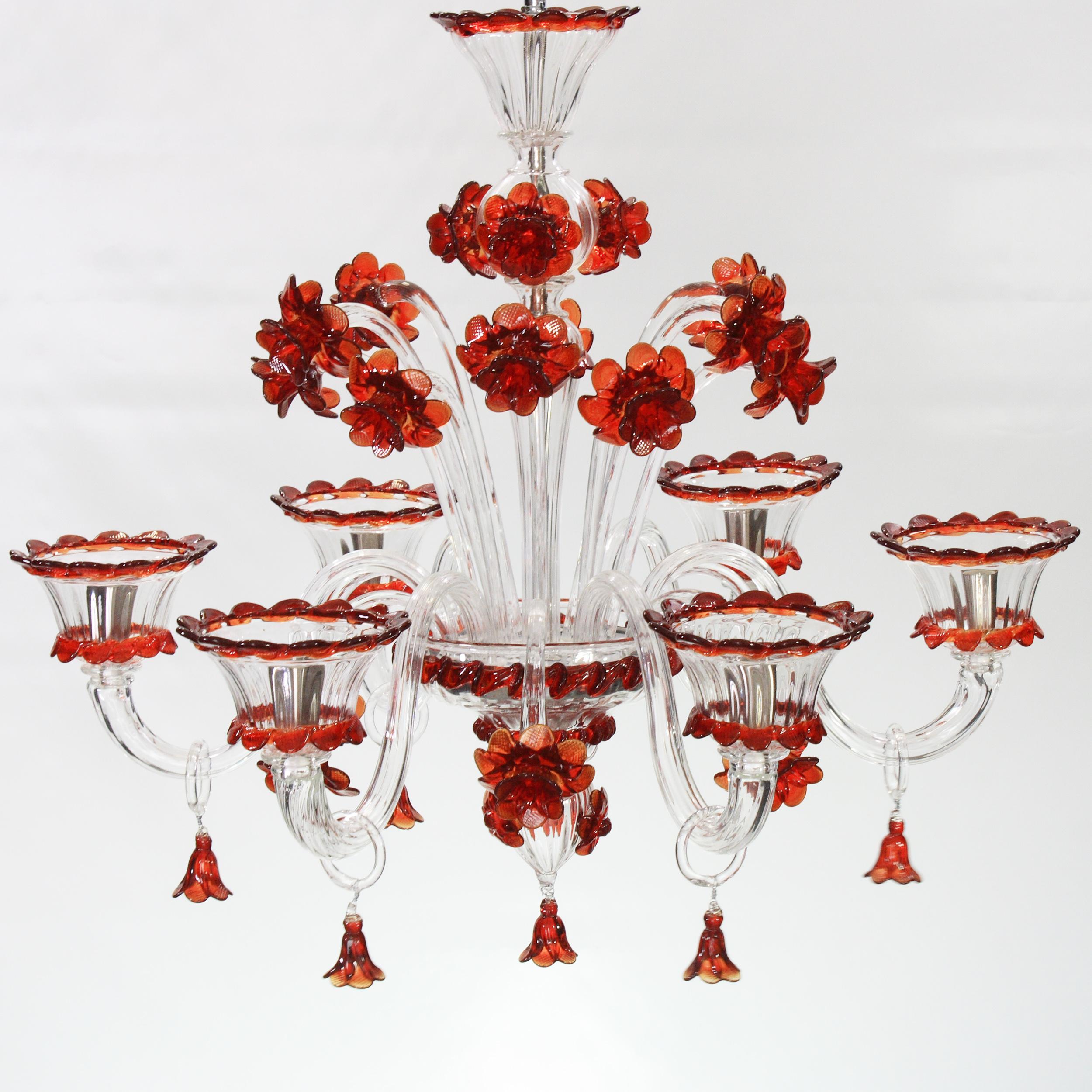 Artistic chandelier 6 lights clear Murano glass and red flowers and details  by Multiforme
This is a classic chandelier composed by a multitude of red flowers. There are also many other details in red galss on the cups and on the arms. 
Our glass