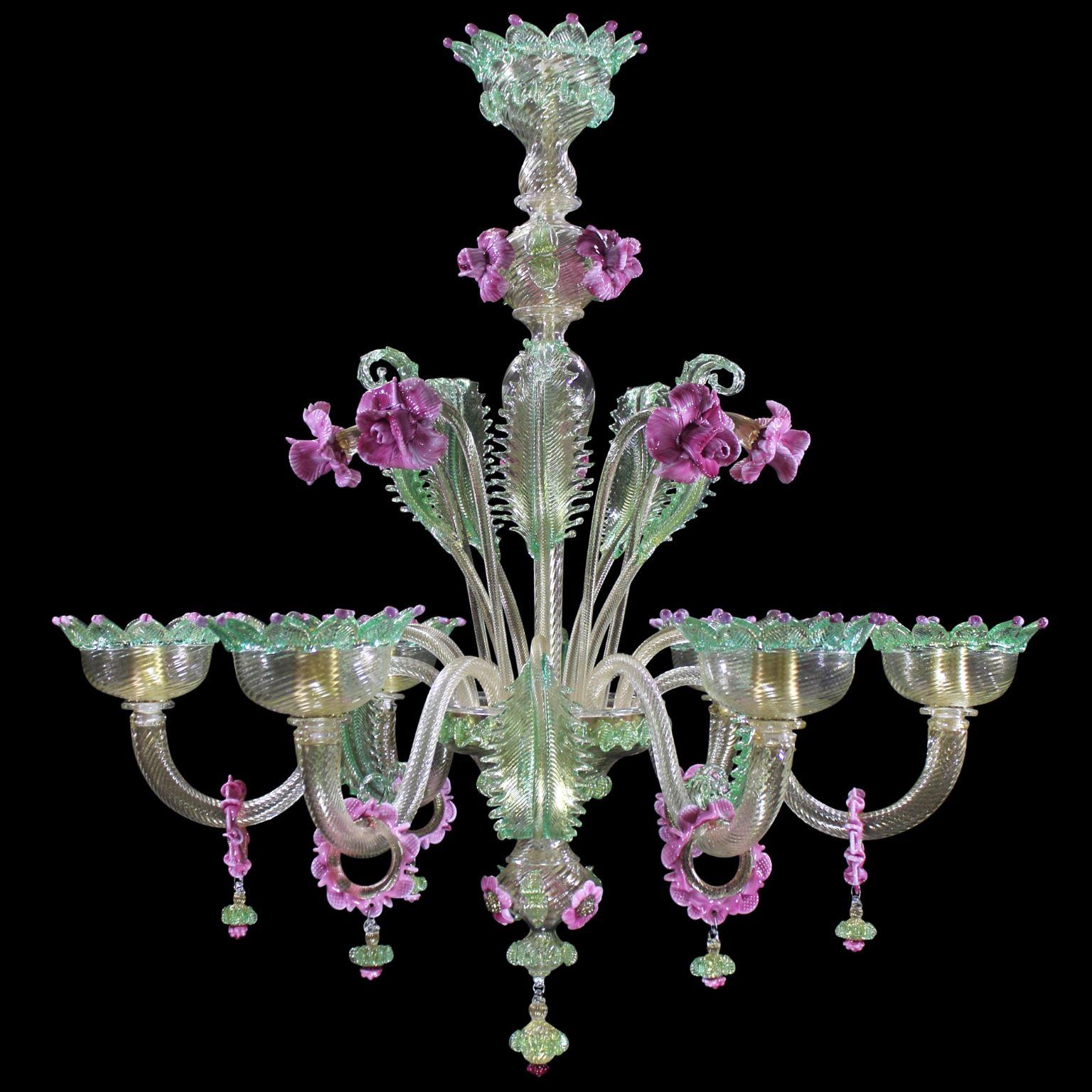 Artistic chandelier 6 arms in golden leaf murano glass and green and pink details.
The peculiar characteristic of this lighting work is the richness of its decorations. 
It reflects the authentic murano glass tradition, which has become famous