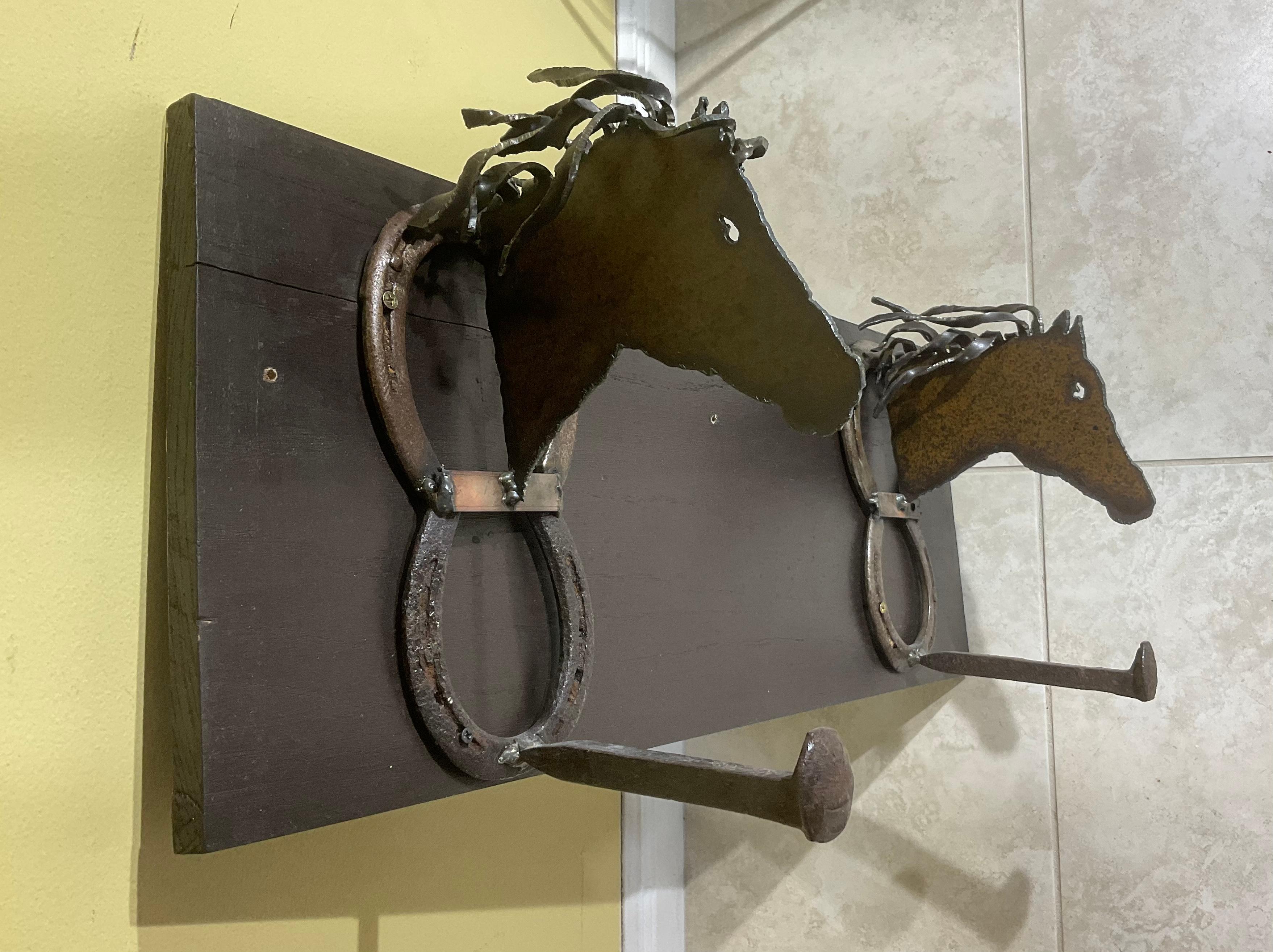 This elegant shelf hand Crafted and features a decorated wall bracket, beautiful iron work of horses heads, horseshoes posted on solid wood back. The shelf is in very good condition.
 