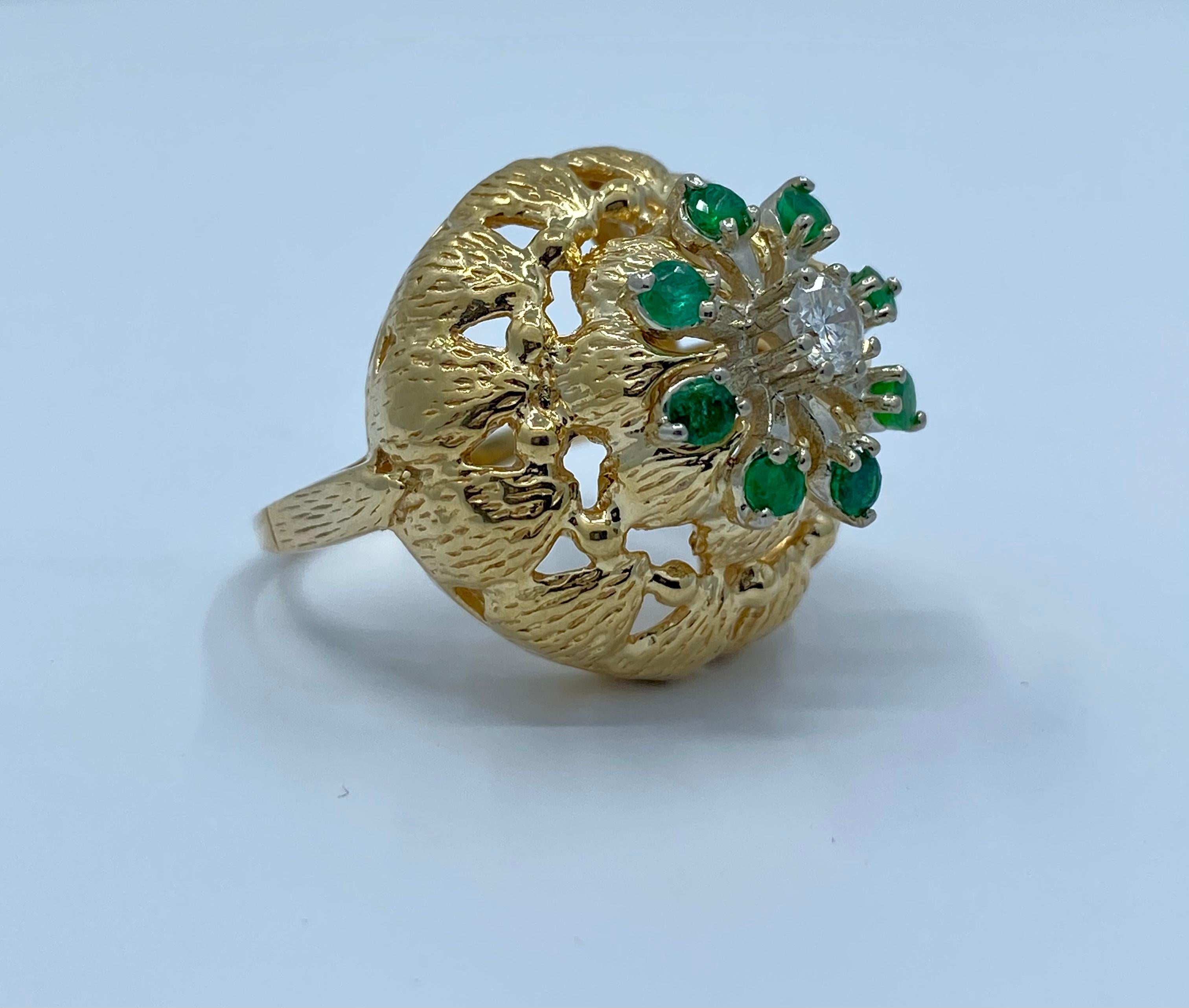 Very unique and artistic, custom-made, mid-century flower motif estate dome ring, features eight vivid green round Columbian emeralds and one round brilliant sparkling diamond in the center adorning the face. Unique as could be, this flower motif