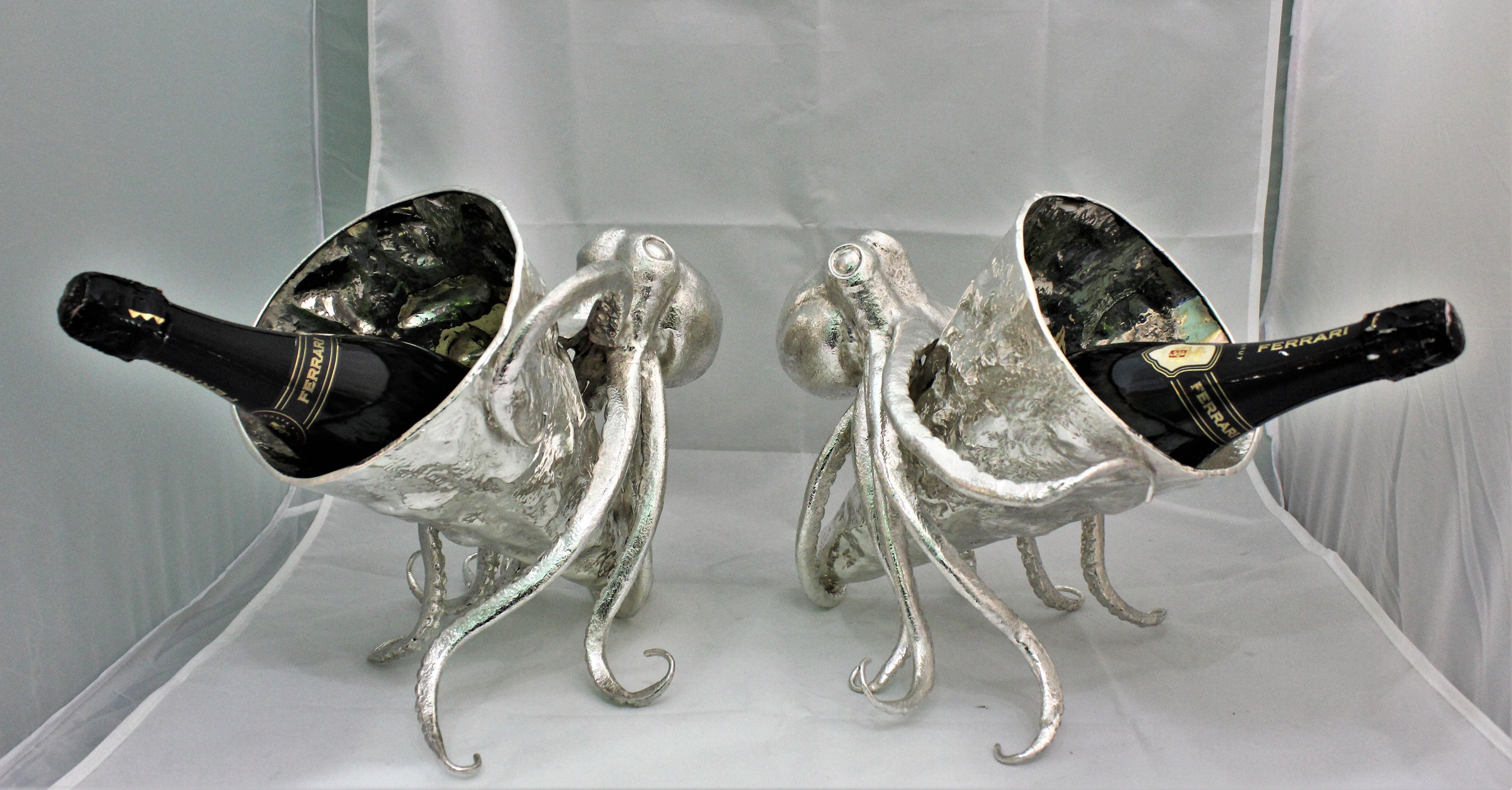 Wonderful pair of silver wine coolers realized around 1930s by a master silversmith from Palermo, Italy.

The wine cooler is cone shaped and hand embossed and hammered to look like sea rocks.

The cone is hold, or better embraced, by the 8