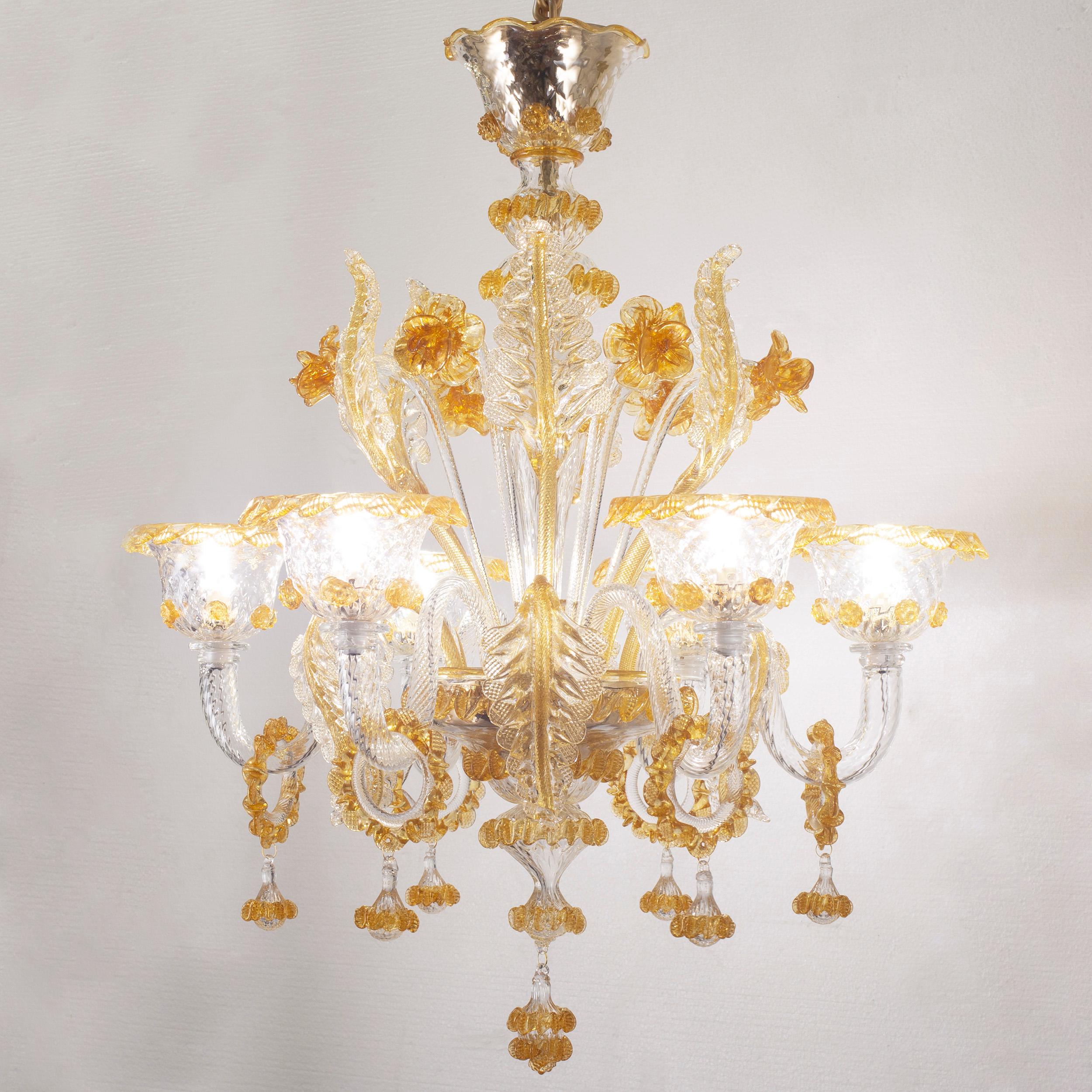Galliano chandelier, 6-light, crystal, and amber Murano glass by Multiforme.
This artistic glass chandelier has 6-light, is completely handmade. 
Galliano is our tribute to the authentic Murano glass tradition. It requires extremely complex and slow