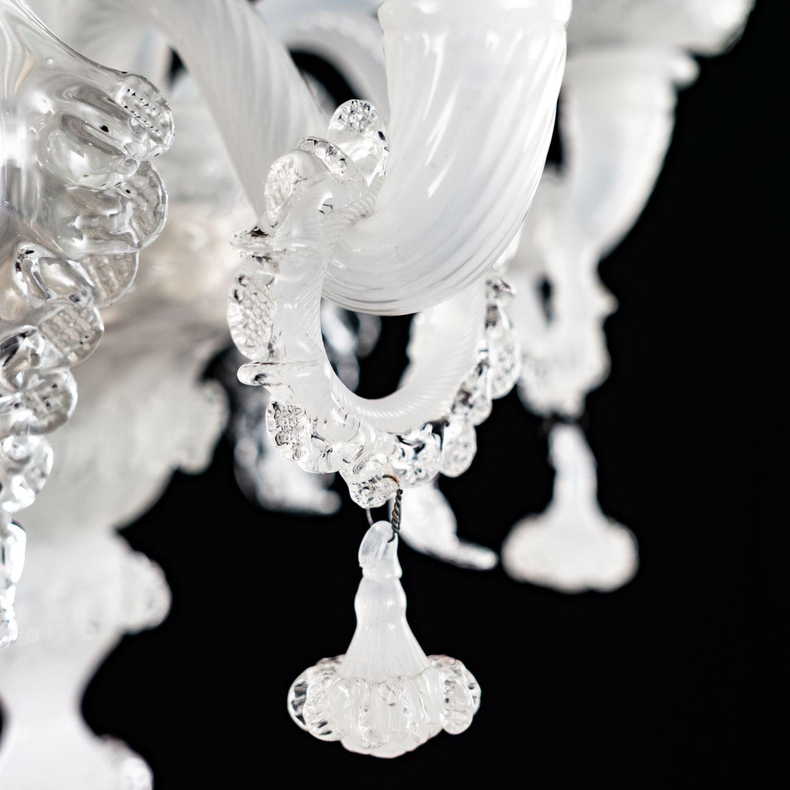 The peculiar characteristic of the Galliano lighting collection is the richness of its decorations.
This artistic glass chandelier has 5-lights, is handmade in white silk and crystal glass.
Galliano is our tribute to the authentic Murano glass