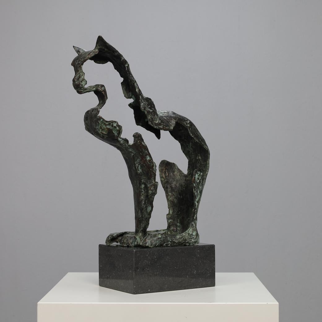 A poetic abstract bronze sculpture that evokes the strength and elegance of a feline with minimal form. The suggestive contours give the piece an open, breathing quality that balances motion and stillness. Its raw texture and deep green patina