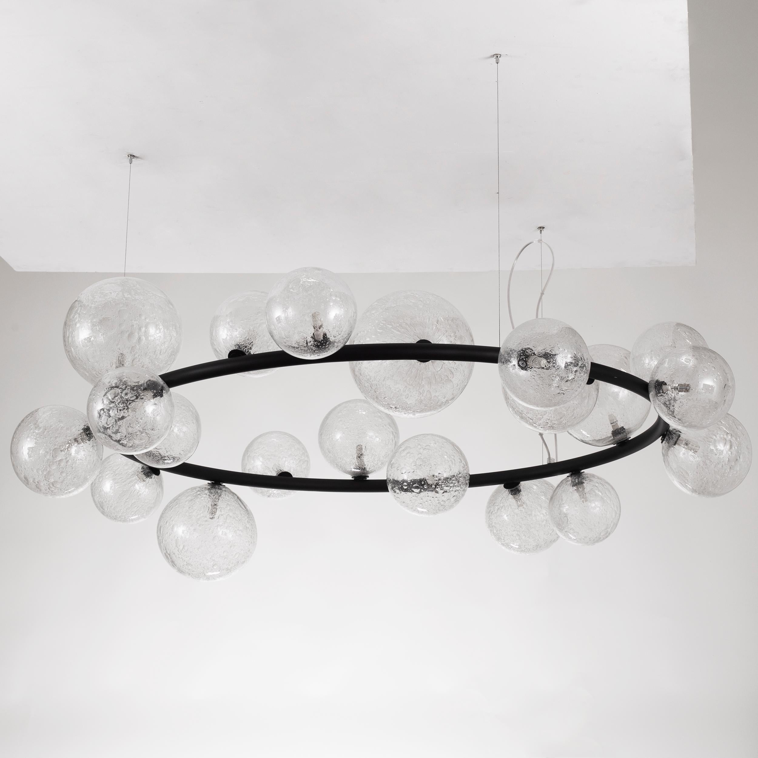 The Murano blown glass suspension has been designed with the aim of subverting the tradition and re-think of new decorative lighting solution. This lighting work is composed by irregular and asymmetric elements, but overall, it is characterized by