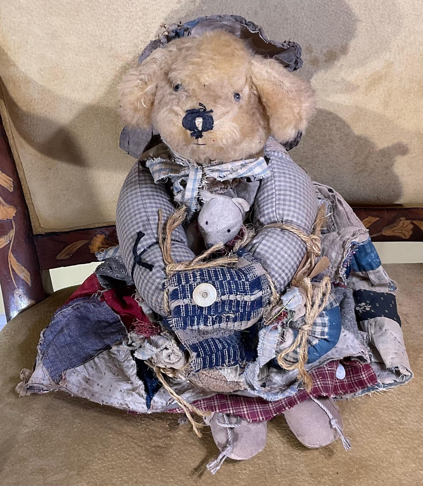 American bear from the 20th century , the bear is nicely hand made with old fabric and have  revealing its great use.  the bear wearing kind of accessories included mother of pearl bottoms, and small baby bear in the middle ,charming look , Ideal to