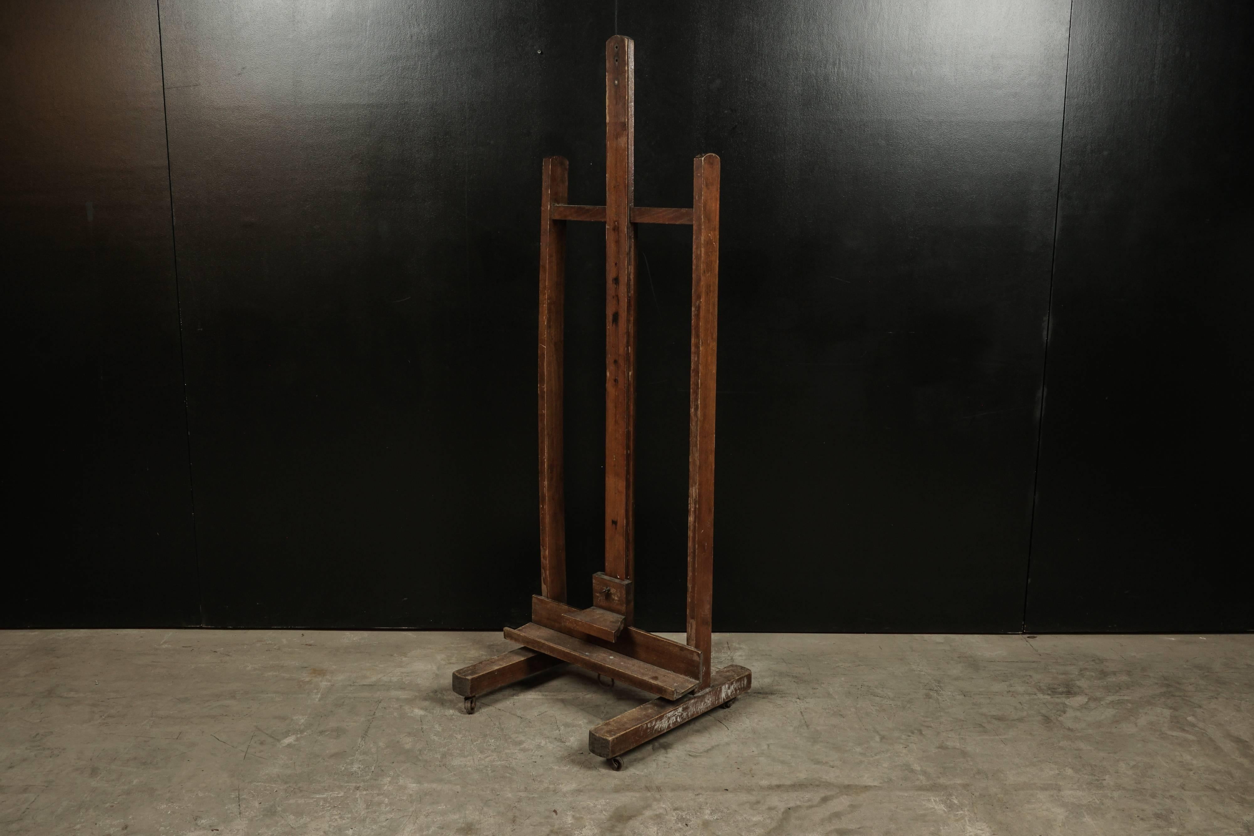 Artist's easel from France, circa 1940. Original hardware with caster wheels. Adjustable height. (Measured height is pictured).