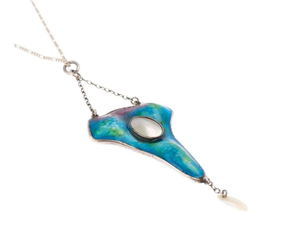 GEMMOLOGIST'S NOTES
This breathtaking arts and crafts pendant, with full hallmarks for Birmingham 1908 and makers marks for Gourdel Vales.

The gorgeous design models delicate curves, both the front and back is delicately covered in variegated blue,