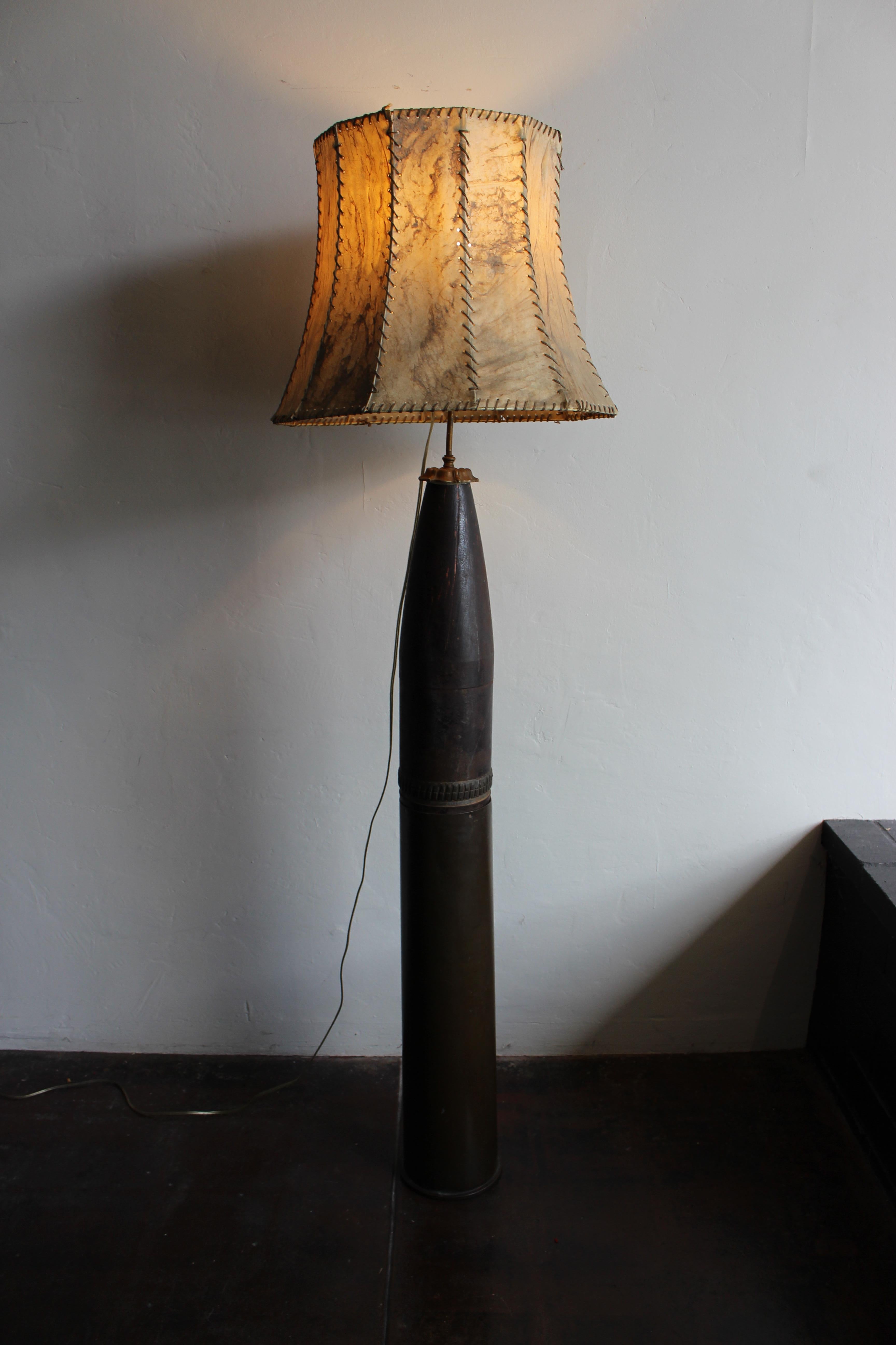 1918 Mortar Shell converted in to the floor lamp .Brass base and metal,probably from the World War I period .
Leather parchment lamp shade from the period .Bottom part is all brass .
Shipping US continental in home delivery $ 500