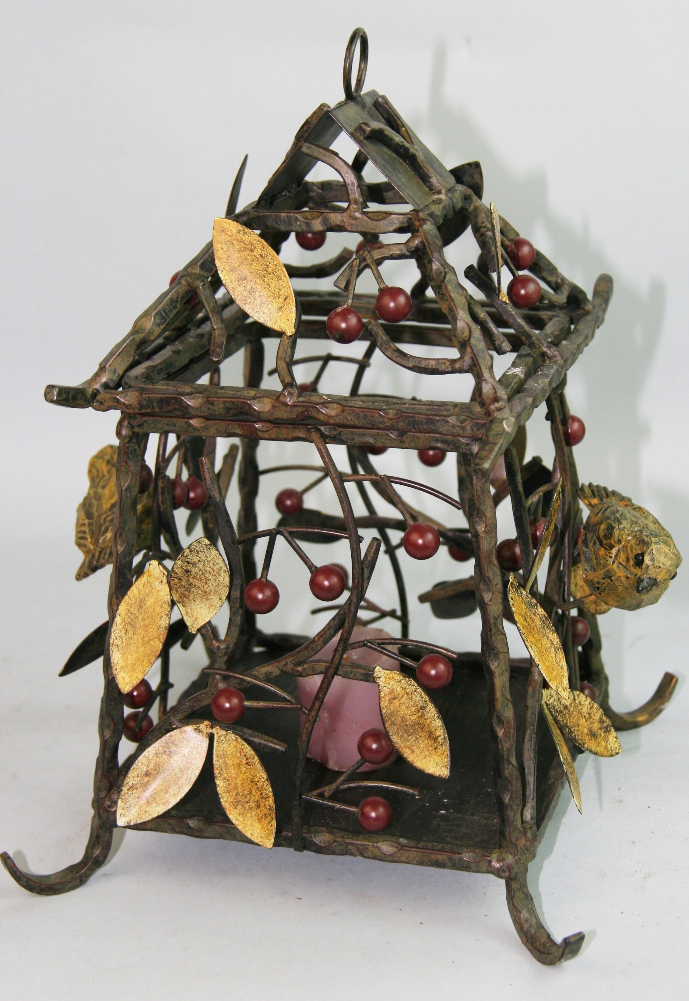 1219 Hand crafted Arts and Craft iron garden lantern supplied with 2 feet of chain.
Top is hinged to place candle/bulb ( can be wired for 60 watt bulb)
Twisted metal construction with hand painted leaves and berries with 2 cast birds