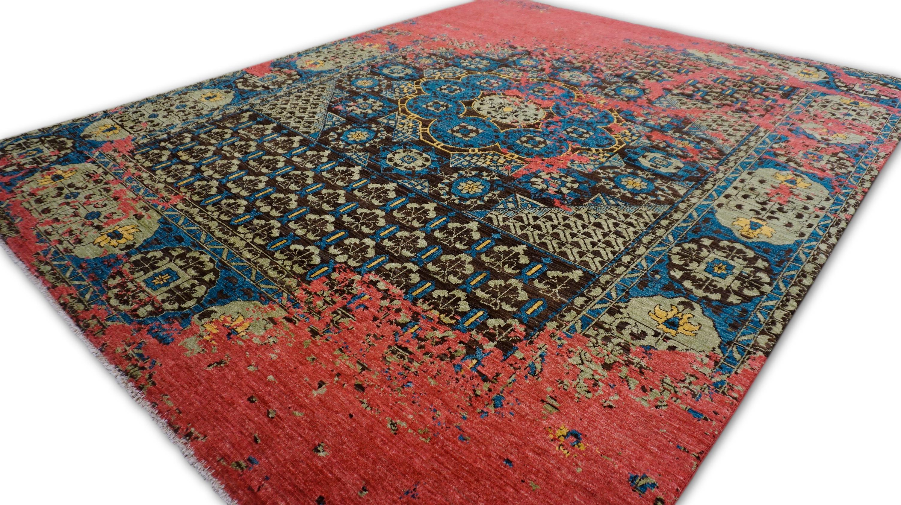 This rug is a Contemporary Persian Revival hand-knotted wool rug, creatively reimagined with a distressed overlay that bridges classical motifs and modern aesthetics. Rug features a traditional Mamluk and corner design with intricate floral motifs,