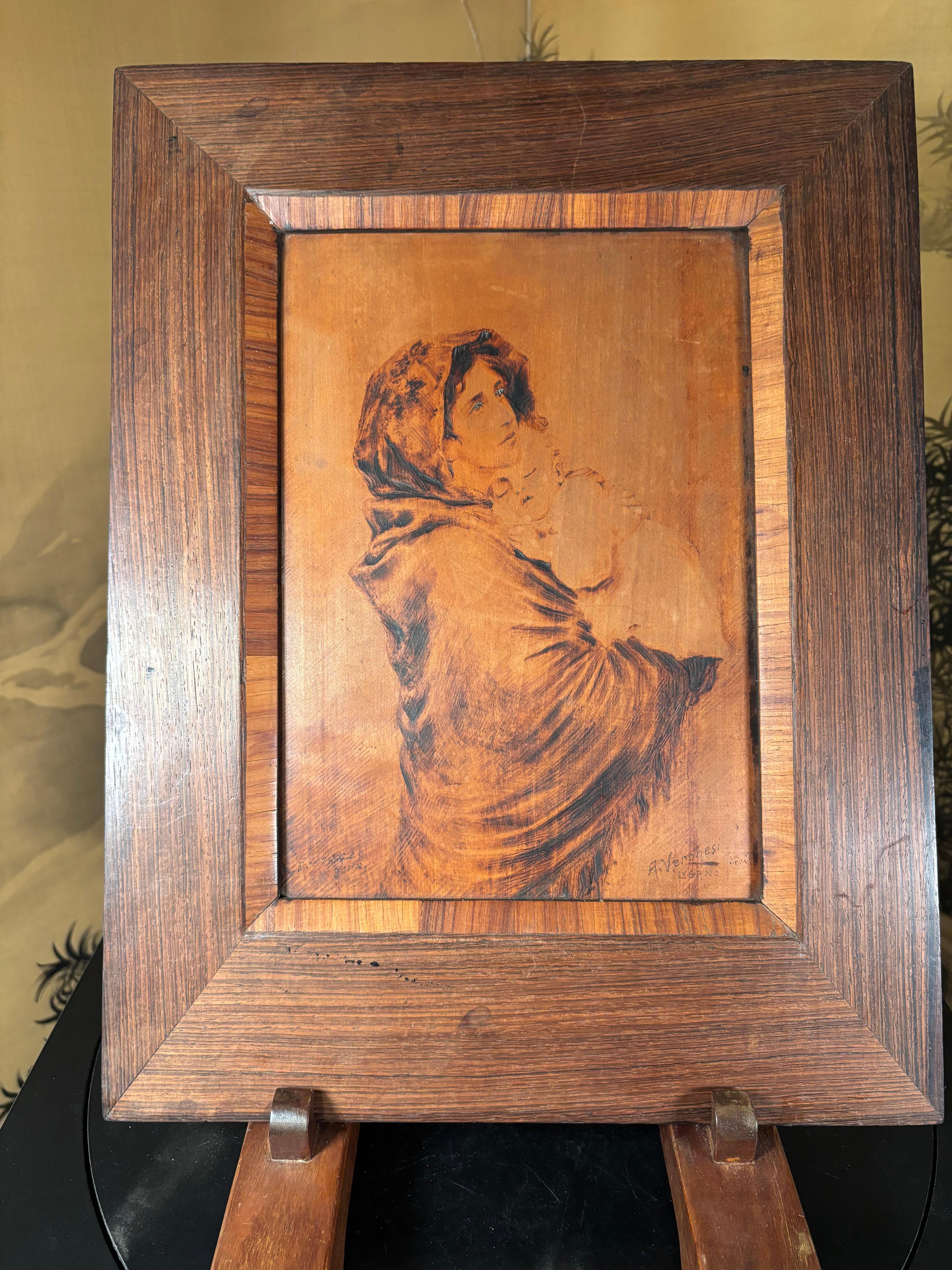 
A sensitive and superb antique Arts and crafts pyrography portrait of  a robed mother with her sleeping infant in arms.

This unique work of art is hand incised by a highly skilled artisan using pyrographic techniques. Mounted in an old fine wood