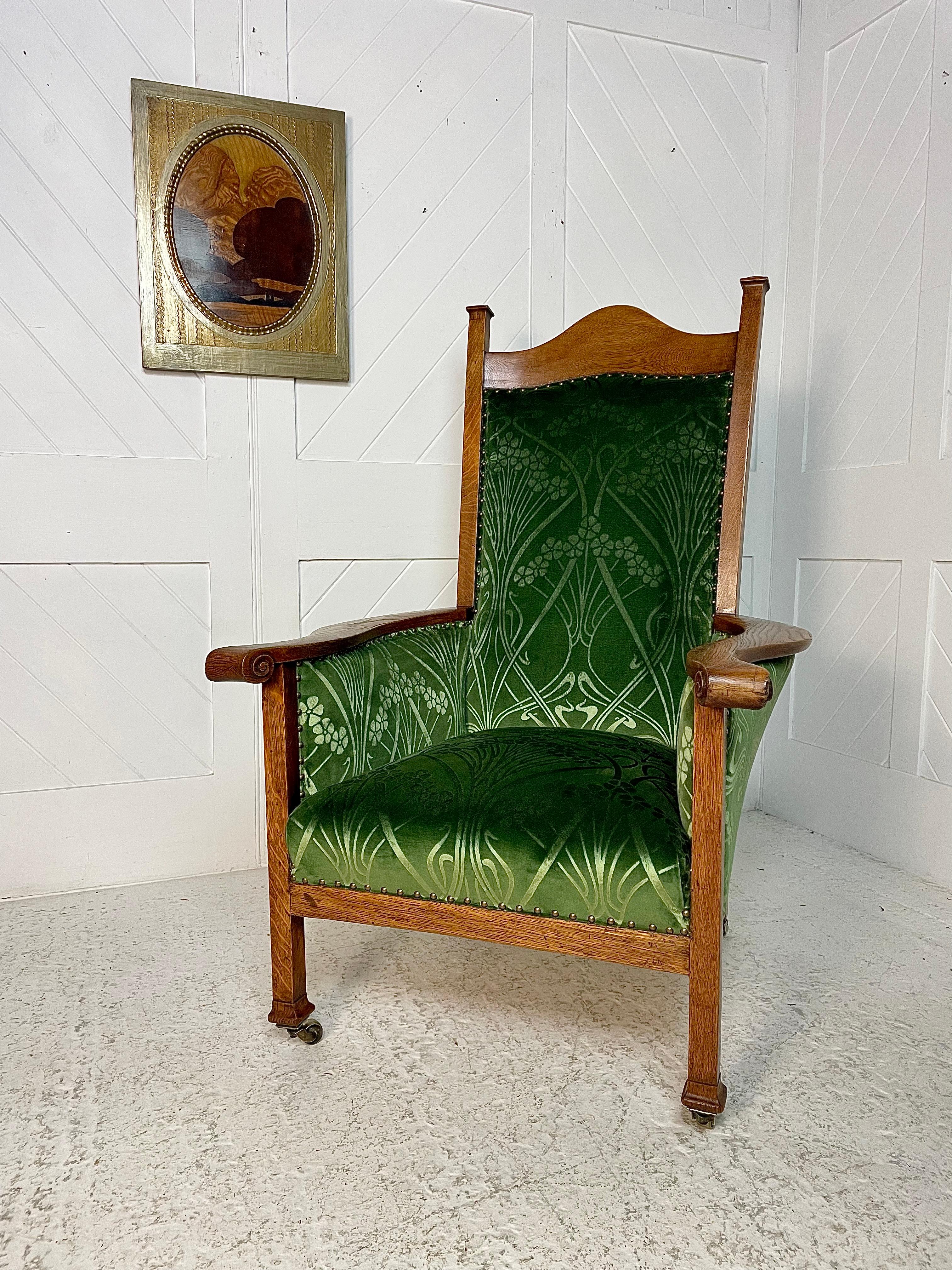 A beautiful generous Arts and Crafts armchair with sweeping arms , arching top rail and pad feet raised on brass castors. This chair has a presence and proportion that is difficult to capture on a camara its a statement piece designed in every way