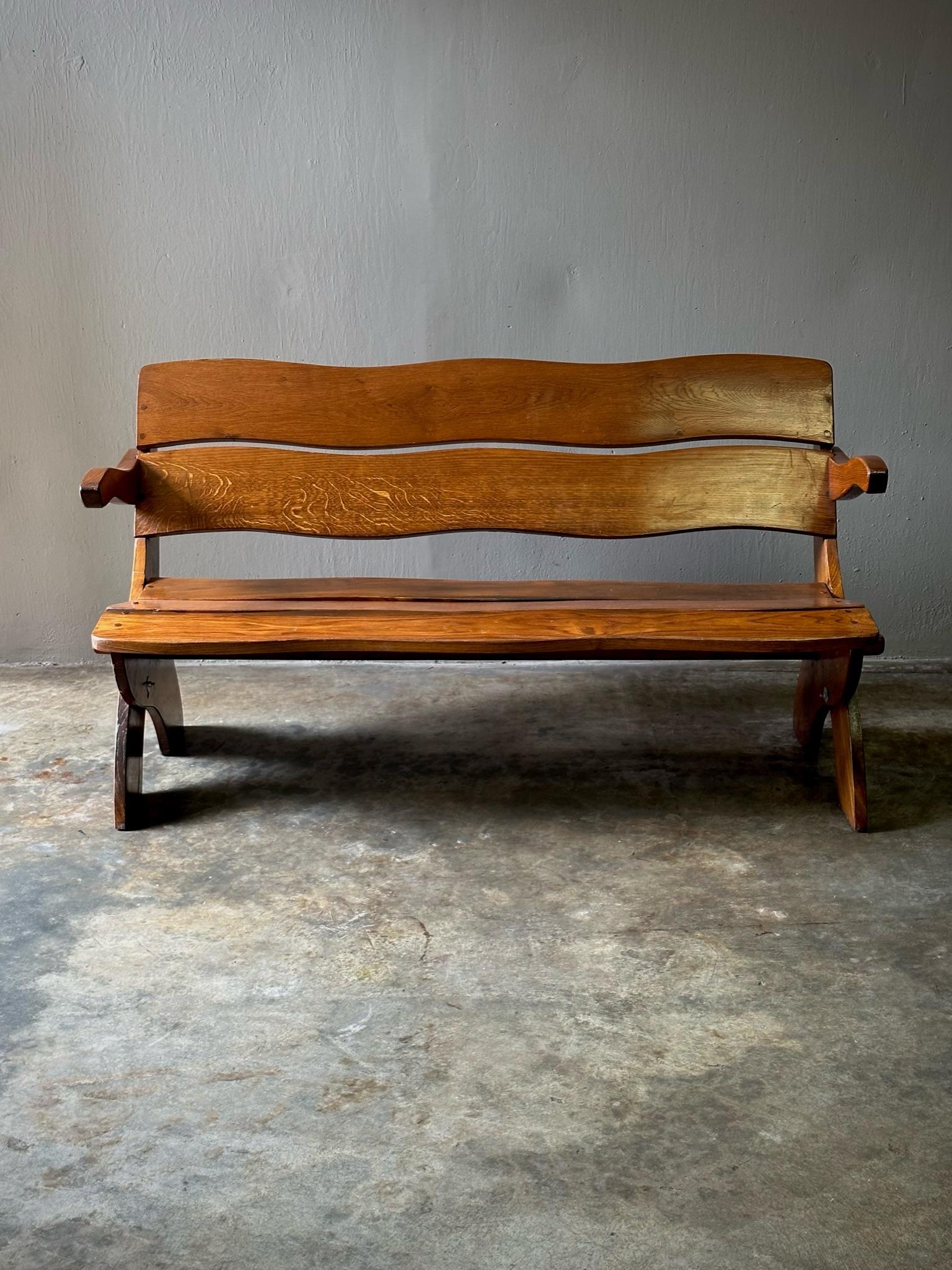Arts and Crafts bench with beautifully detailed joints and organically shaped seat and back.

Netherlands, circa 1960

Dimensions: 55.5W x 23D x 30H (seat height 15)