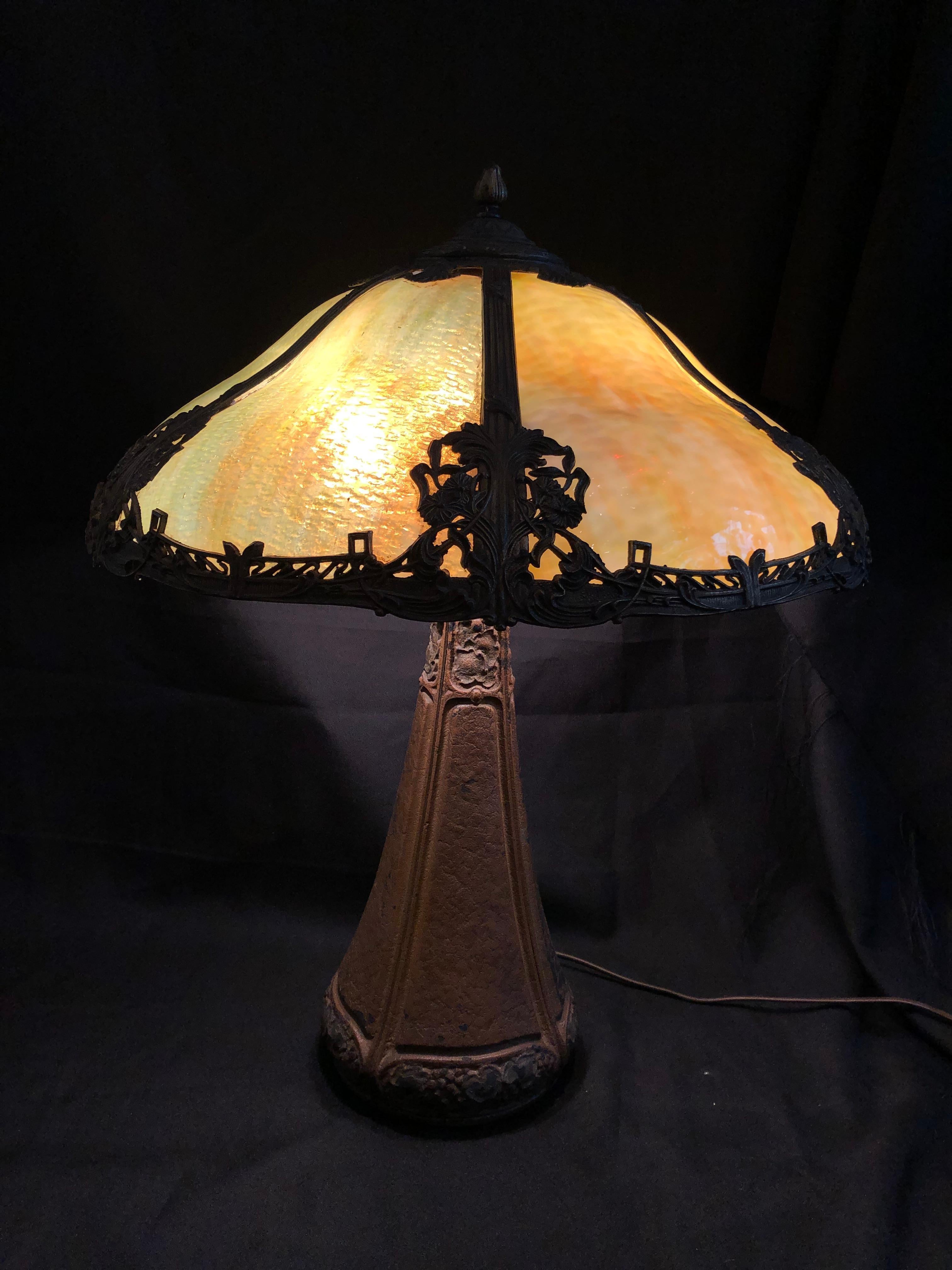 A handsome Bradley & Hubbard cast iron lamp with original finish, aged to an appealing patinated crackle. 

Soft green/ cream slag glass shade. 

The base is signed at the top.