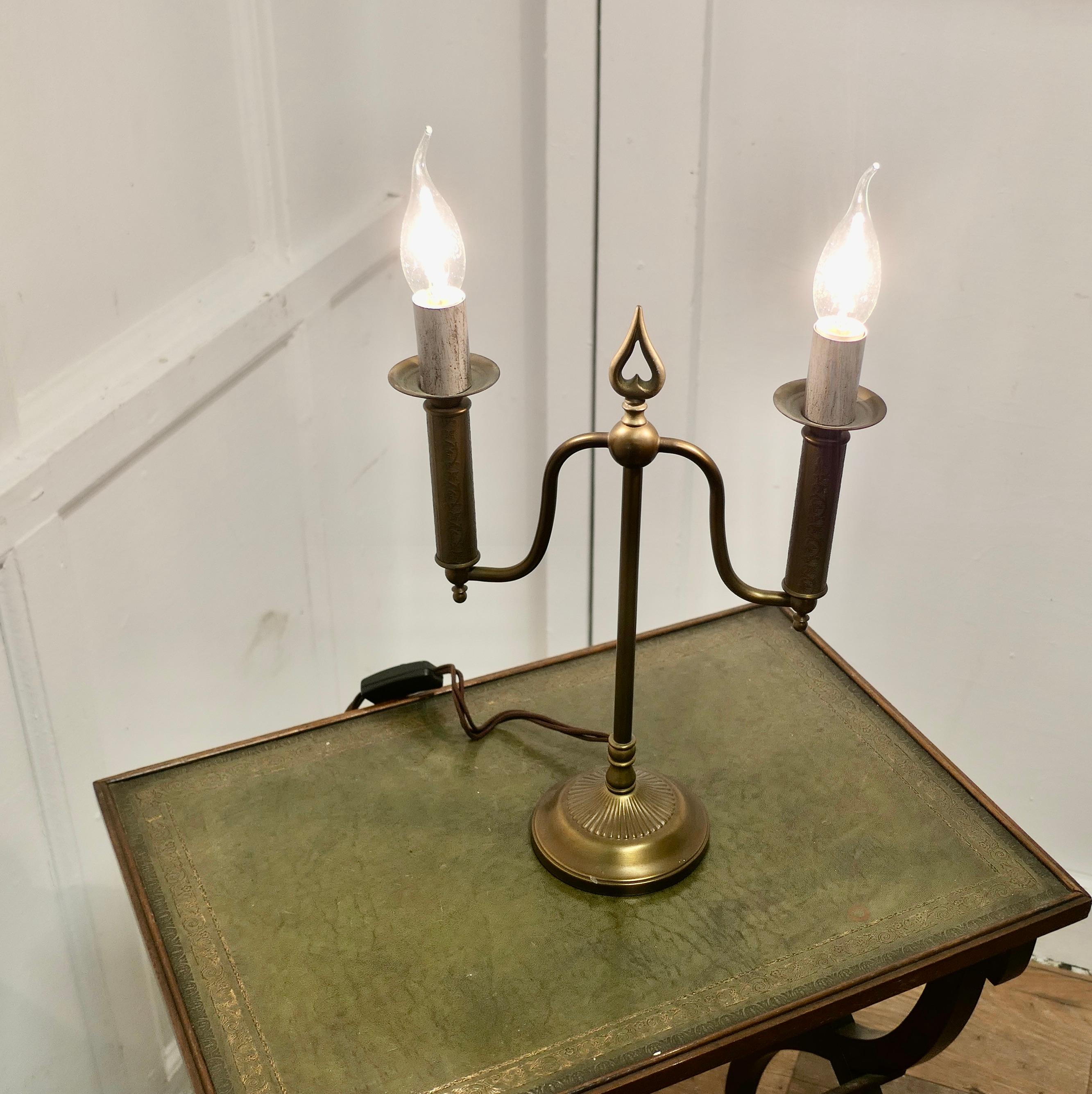 Arts and Crafts Brass Candelabra 2 Branch Lamp

This is a simple and attractive design, the lamp has a slender fluted upright set on a round base which supports a 2 branch candelabra with a Spear Head 

The lamp has relatively new wiring and is in
