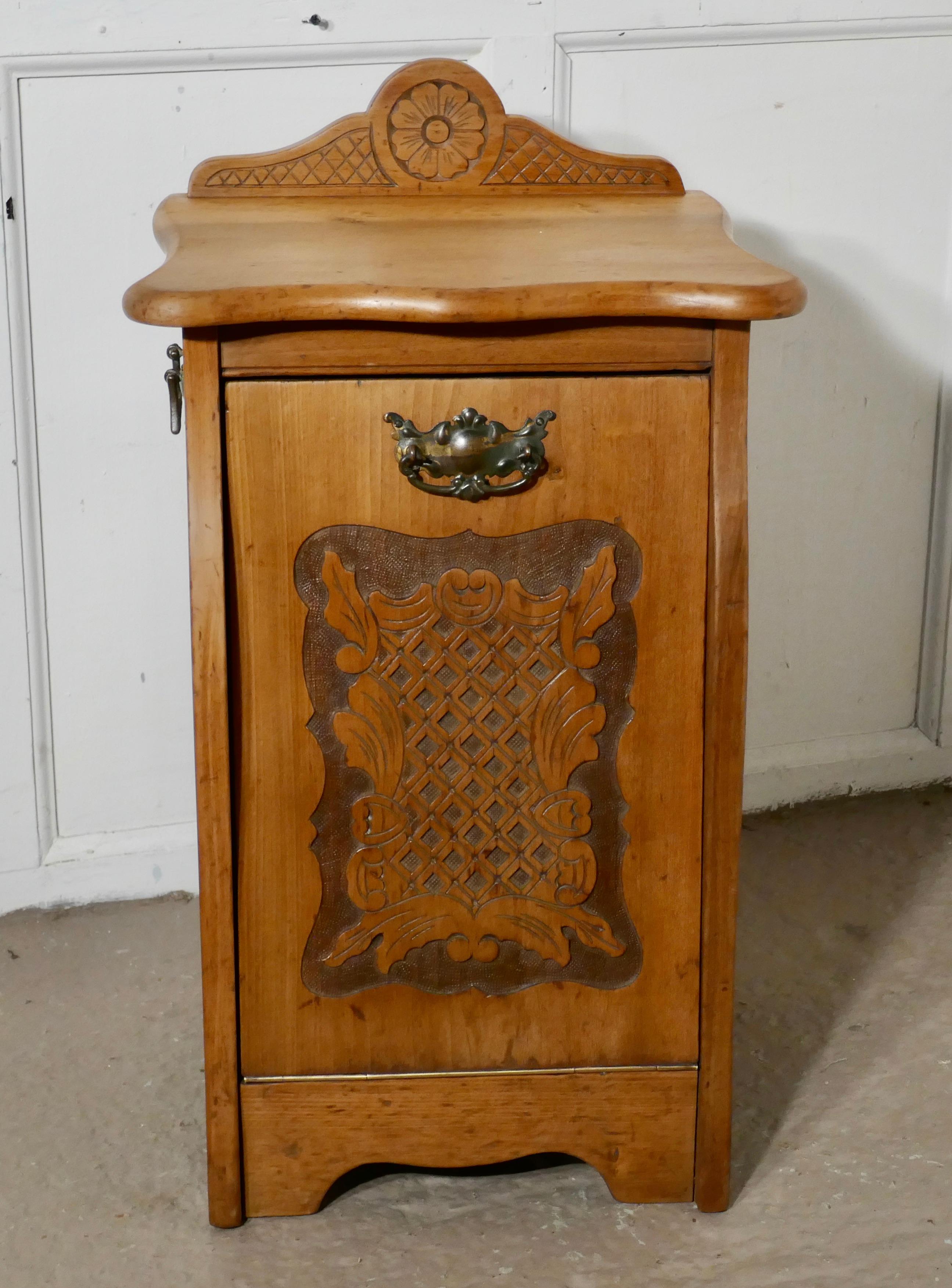 Arts & Crafts carved golden walnut Purdonium, coal box

This is great design, the Purdonium has carved panel on the front, the top has a matching carved gallery at the back and it stands on a shaped base
The front of the box pulls down by the
