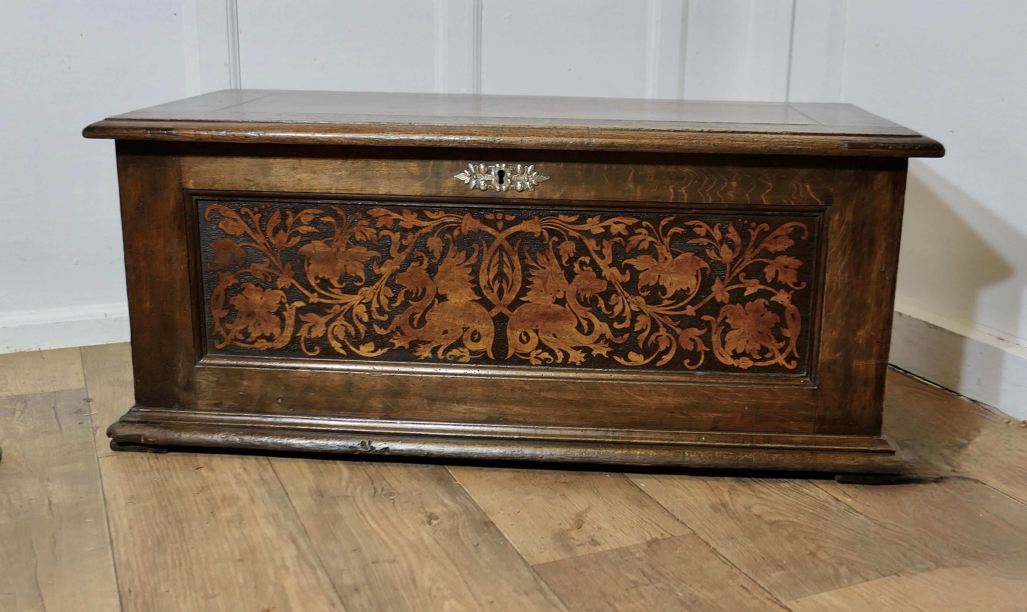 Arts and Crafts Carved Oak Marriage Chest or Carved Coffer

This is a lovely old piece, and is in remarkably good condition for its age, the coffer has gothic carvings of Dragons and fauna on the front and sides 
On the inside there are hand painted