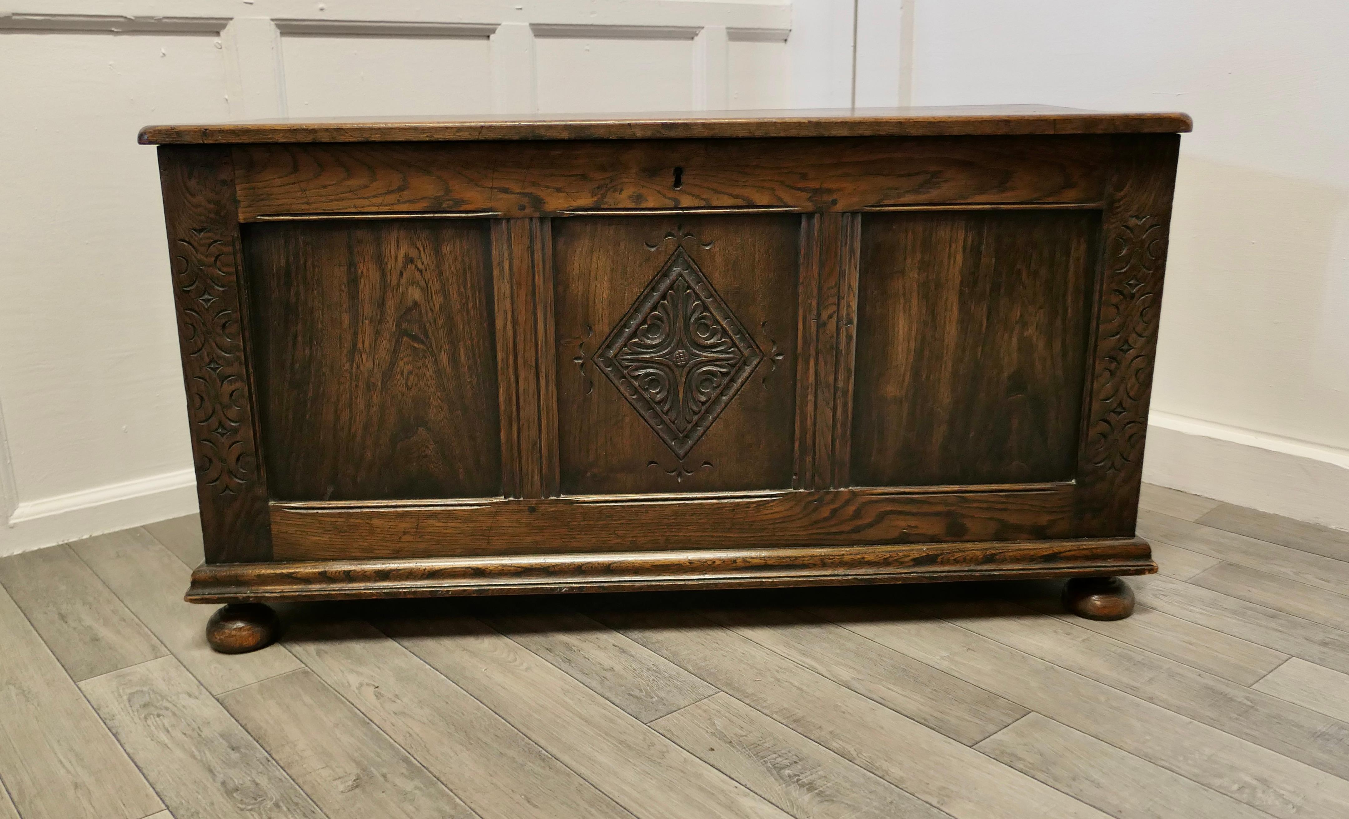 Arts and Crafts Carved Panelled Oak Coffer 

This is a lovely old piece, with a good patina, the chest has three panels on the front, the centre one has a geometric lozenge carving 
The sides and back of the chest have moulded panels and the