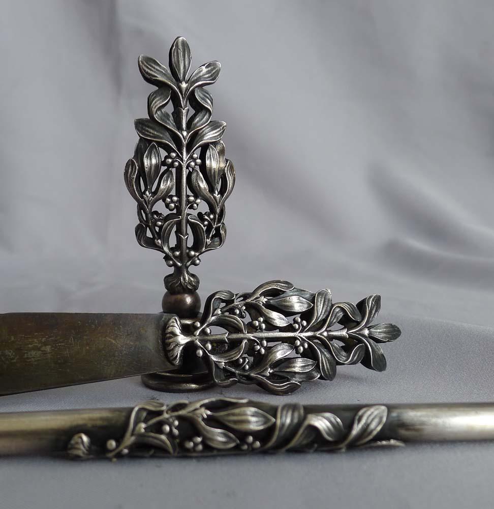 Arts & Crafts cased steel desk set of book mark, seal and pen. Three lovely pieces and in their original silk lined box. The book mark and the seal have hilts beautifully decorated with mistletoe. The dipping pen with mistletoe decoration applied.