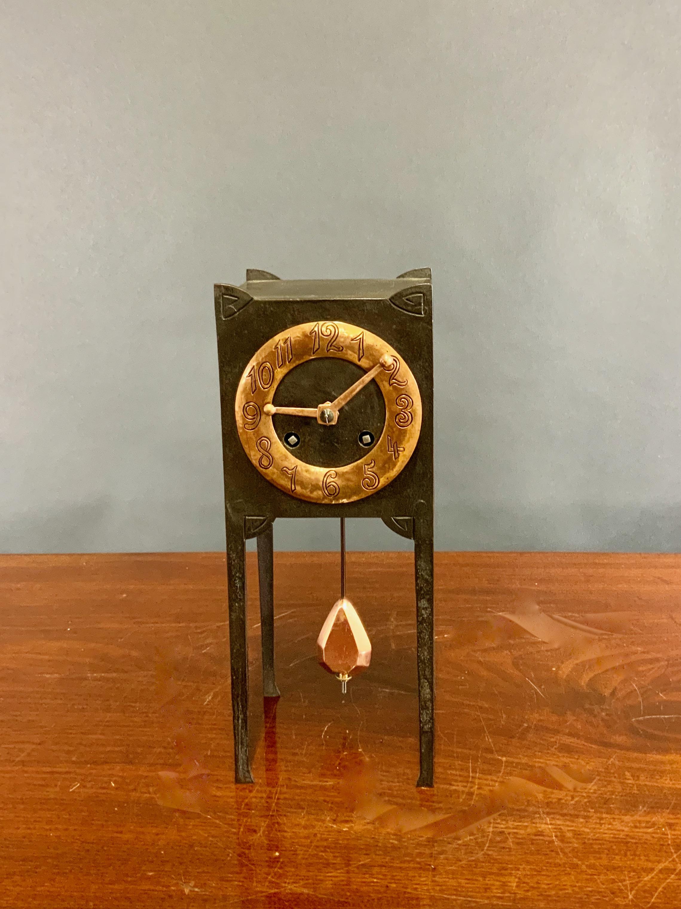 Arts and Crafts Cast Iron and Copper Mantel Clock

A rare and unusual Arts and crafts mantle clock housed in a cast iron square case with decorative corners and long slender legs.

Raised copper dial with Arabic numerals and original copper Arts and