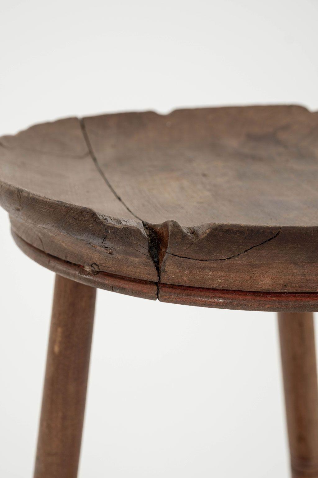 Arts and Crafts concave seated stool, circa 1890-1910, by James Shoolbred and Company. Sturdy decocative stool that can also serve as a drinks or small side table. Perfect amount of wear and wood separation. Made by James Shoolbred & Co, and sold