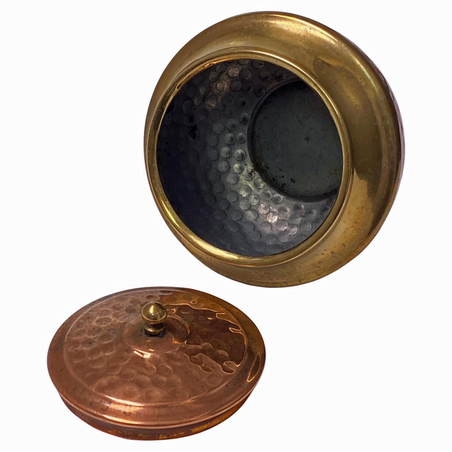 Arts and Crafts Copper and Brass Caddy, Continental C.1910. The Caddy on invert brass pedestal foot, bombe ovoid hand hammered copper and polished brass body, detachable hammered copper cover with brass finial. Height: 4.20 inches. Opening at top: