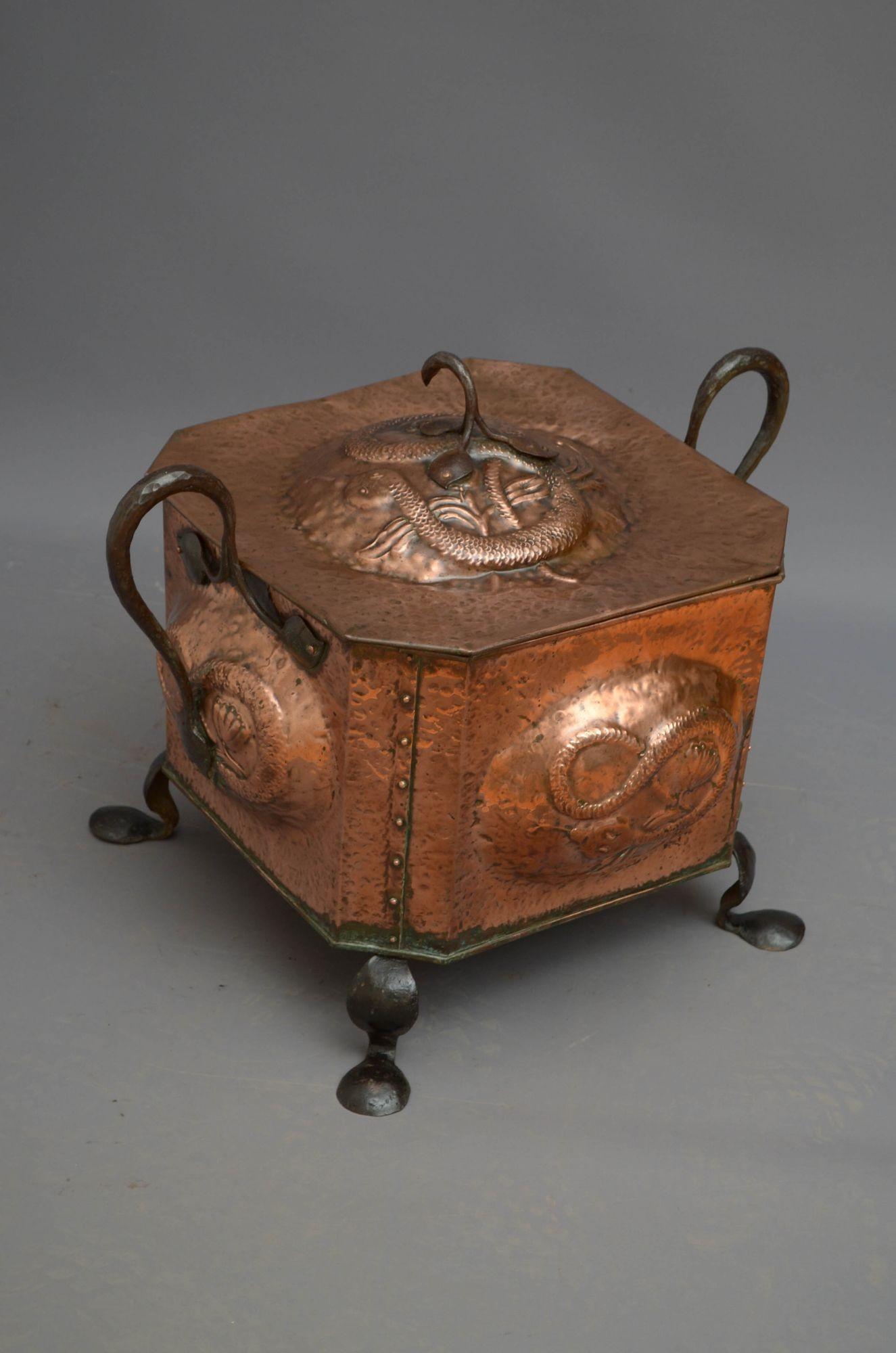 Sn5448 Arts and Crafts coal bucket, having lift up lid depicting a snake fitted with wrought iron handle, four sides with infinity motif also depicted by a snake and two wrought iron handles, all standing on pad feet. This antique coal bin is in